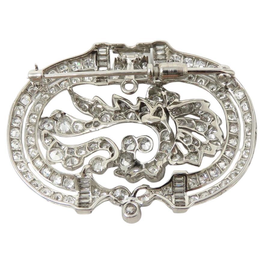Discover the timeless elegance of this antique platinum brooch pendant, adorned with approximately 9 carats total weight of diamonds in the F-G-H color range and VVS/VS clarity. Versatile and stunning, it measures about 44 x 33mm and exudes