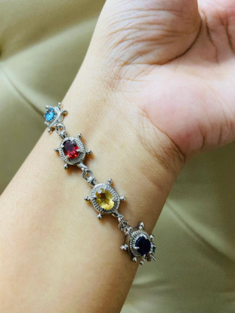 9 Carat Multi Gemstone Link Bracelet Gift for Her in sterling silver showcases endlessly sparkling natural multi gemstone, weighing 9 carat. It measures 7 inches long in length. 
Multi Gemstone stimulate concentration and reduces stress. 
Designed