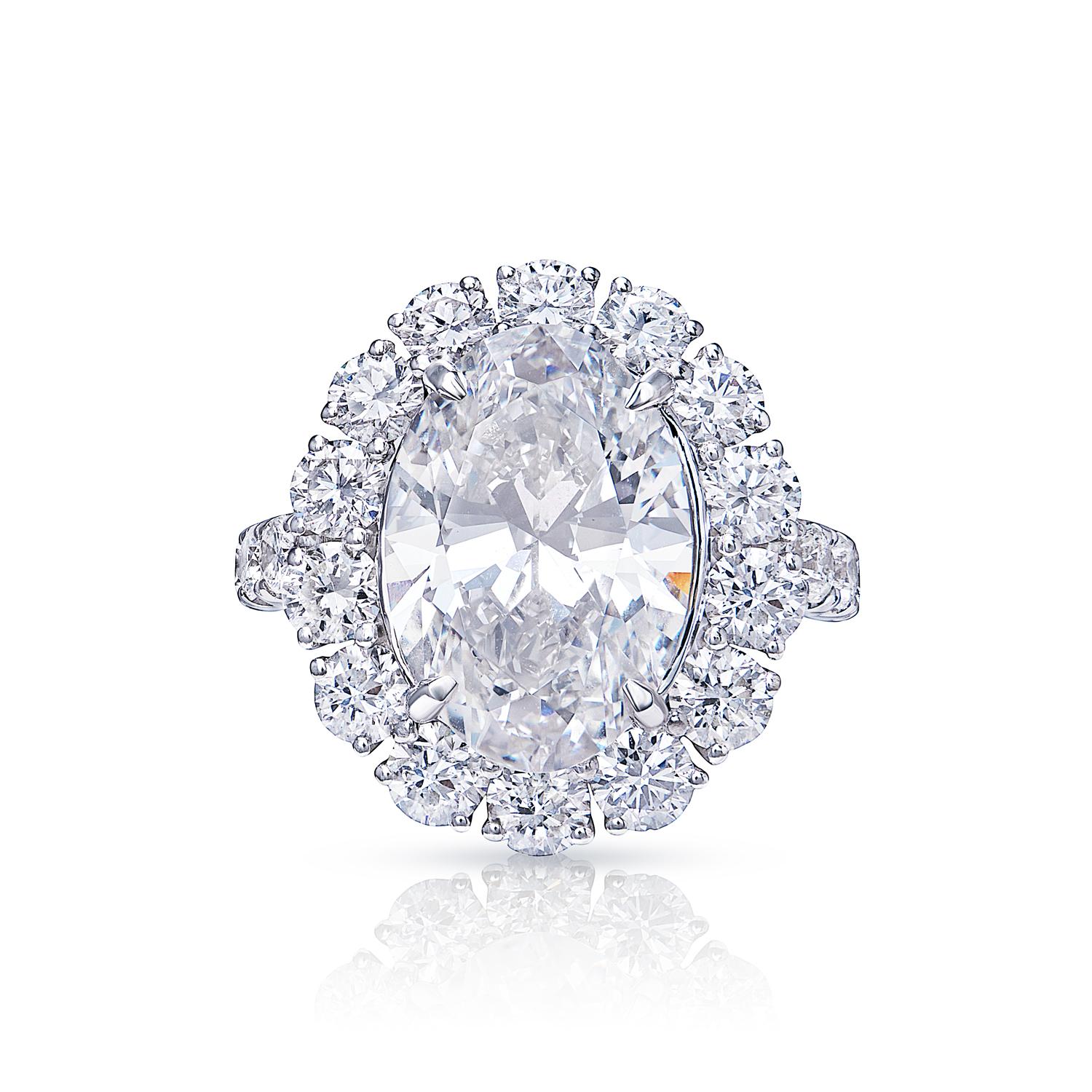 This stunning piece of jewelry features a beautiful oval-cut diamond that is sure to take your breath away. The oval-cut diamond is set in a platinum setting and is accented by two smaller diamonds on either side. The ring also has a split shank