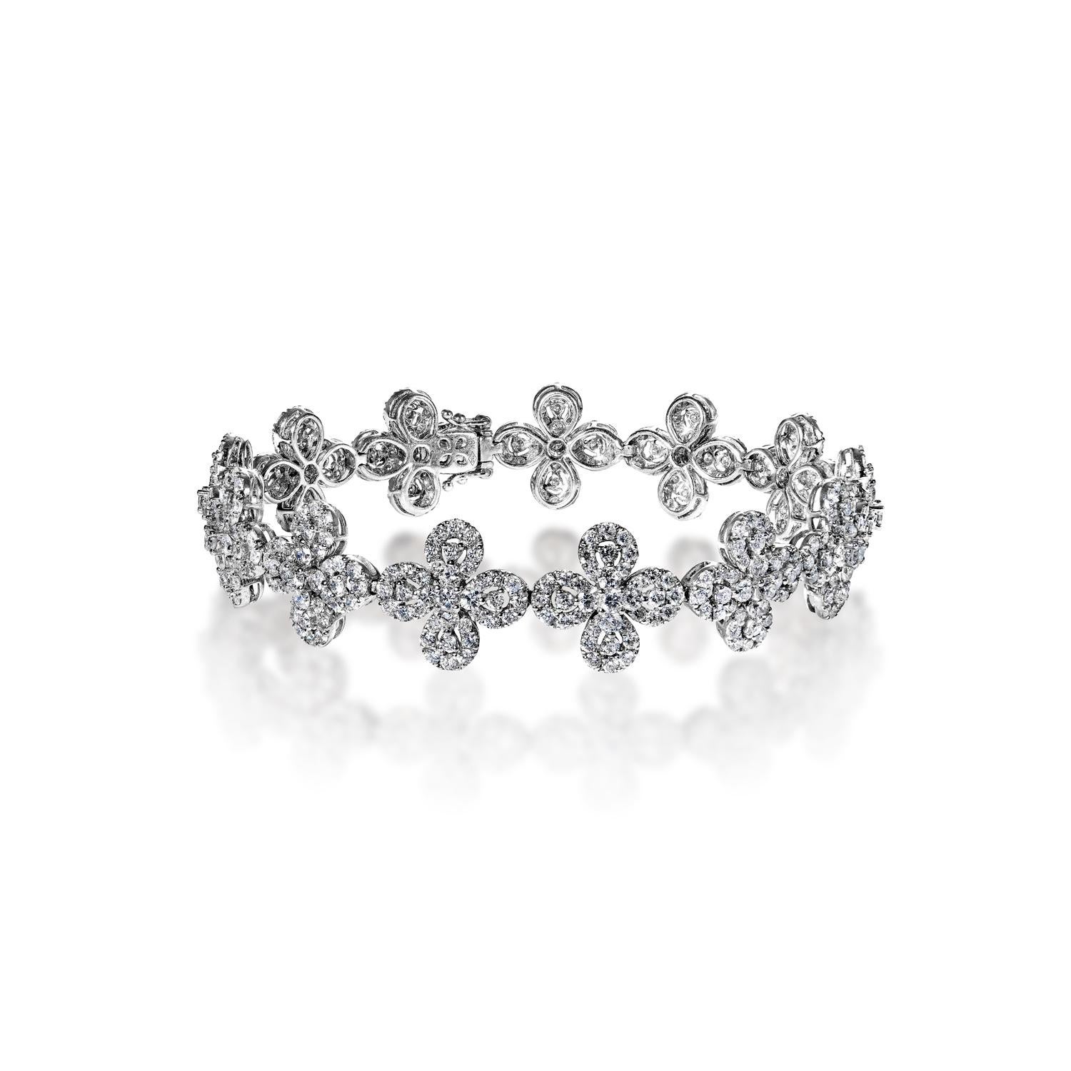 This gorgeous floral design diamond bracelet is exquisitely crafted with 18 karat white gold. Intricately set with 8.76 carats of round brilliant cut diamonds, this stylish piece adds an elegant touch to any outfit. Carefully secured with a box