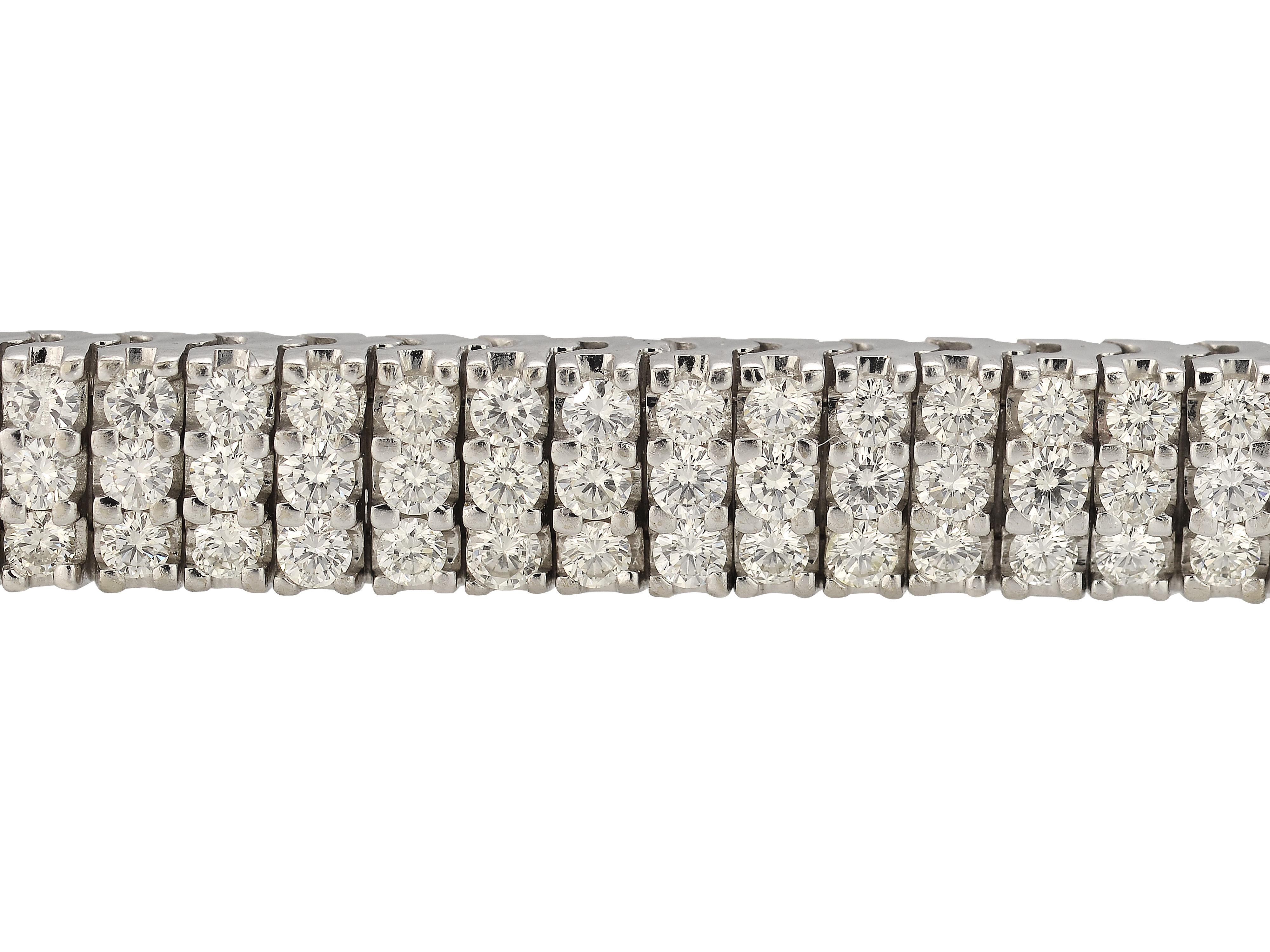 14 Karat White Gold Articulated Three Row Bracelet Featuring 225 Prong Set Round Brilliant Cut Diamonds Totaling Approximately 9 Carats Of VS Clarity & J Color. Hidden Safety Under Clasp For Extra Security.