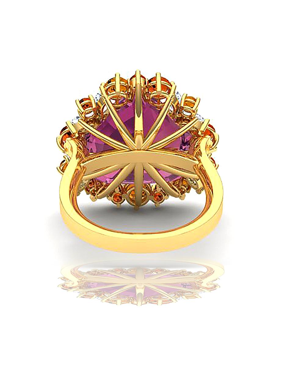 A center stone that's unique in its cut and color centers this fun and rare cocktail ring.  The center of this ring is a Pink Tourmaline which is pear shield cut and weighs over 9.5 carats.  The center is complimented by orange sapphire and orange