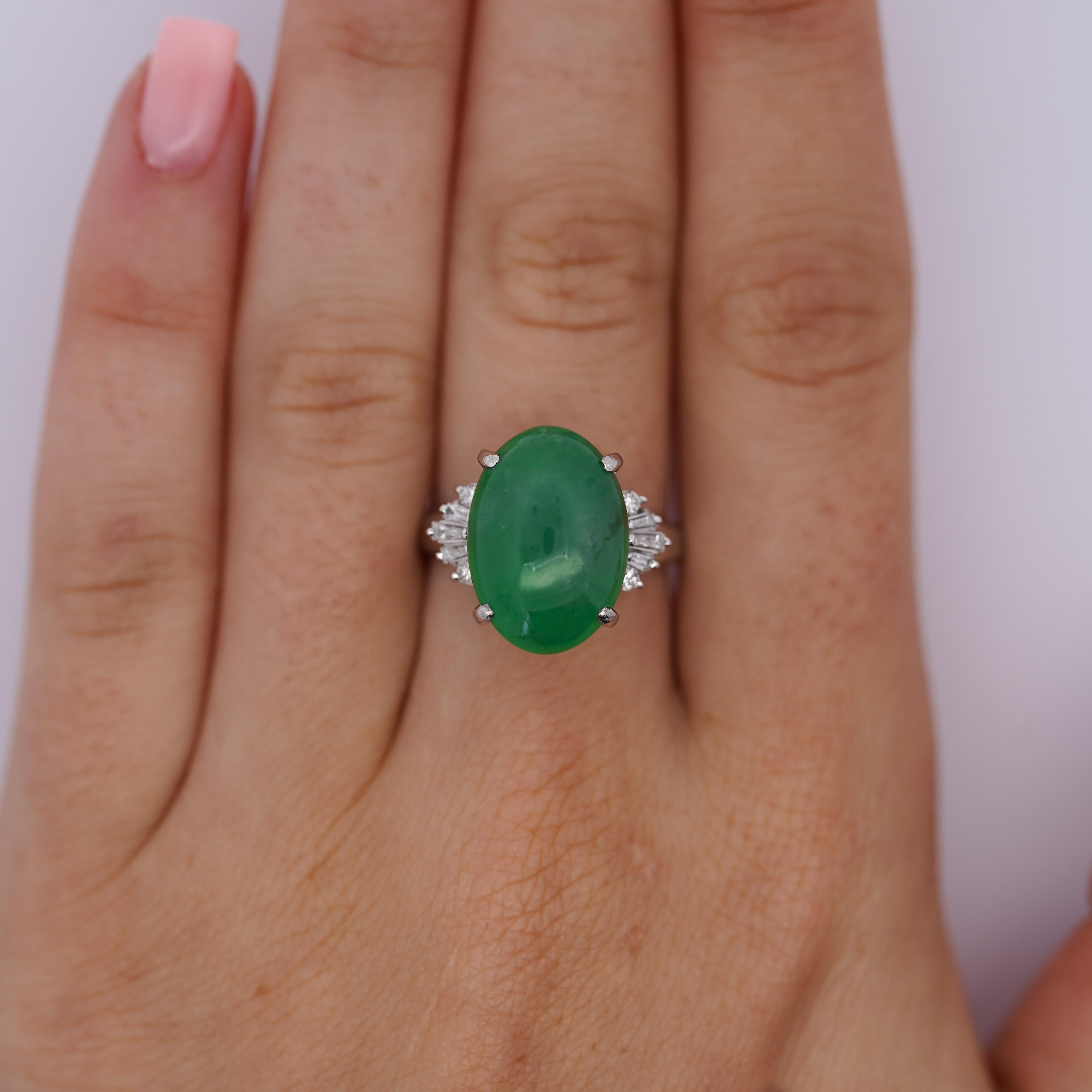 This exquisite ring features a sophisticated platinum split band, displaying a striking stone arrangement. At its heart lies a captivating untreated HK Jade & Stone lab certified oval cut jade for added depth and allure. Surrounding this stunning