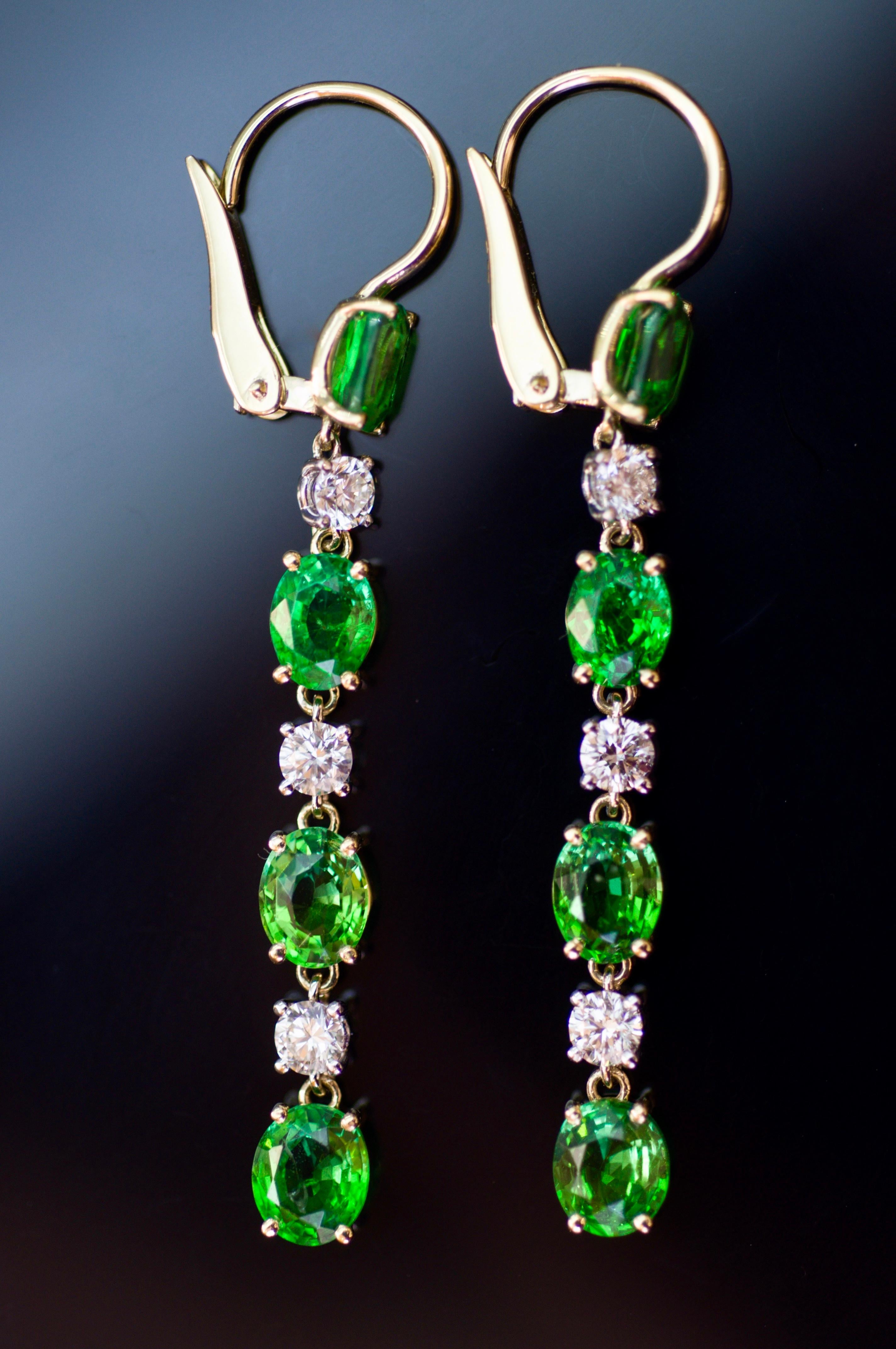 These earrings are very elegant and attractive - yellow gold, diamonds and tsavorites with neon rich green color from Tanzania. 
With such earrings you could make any of your outfits looking fabulous. 
They will move with every step you make and