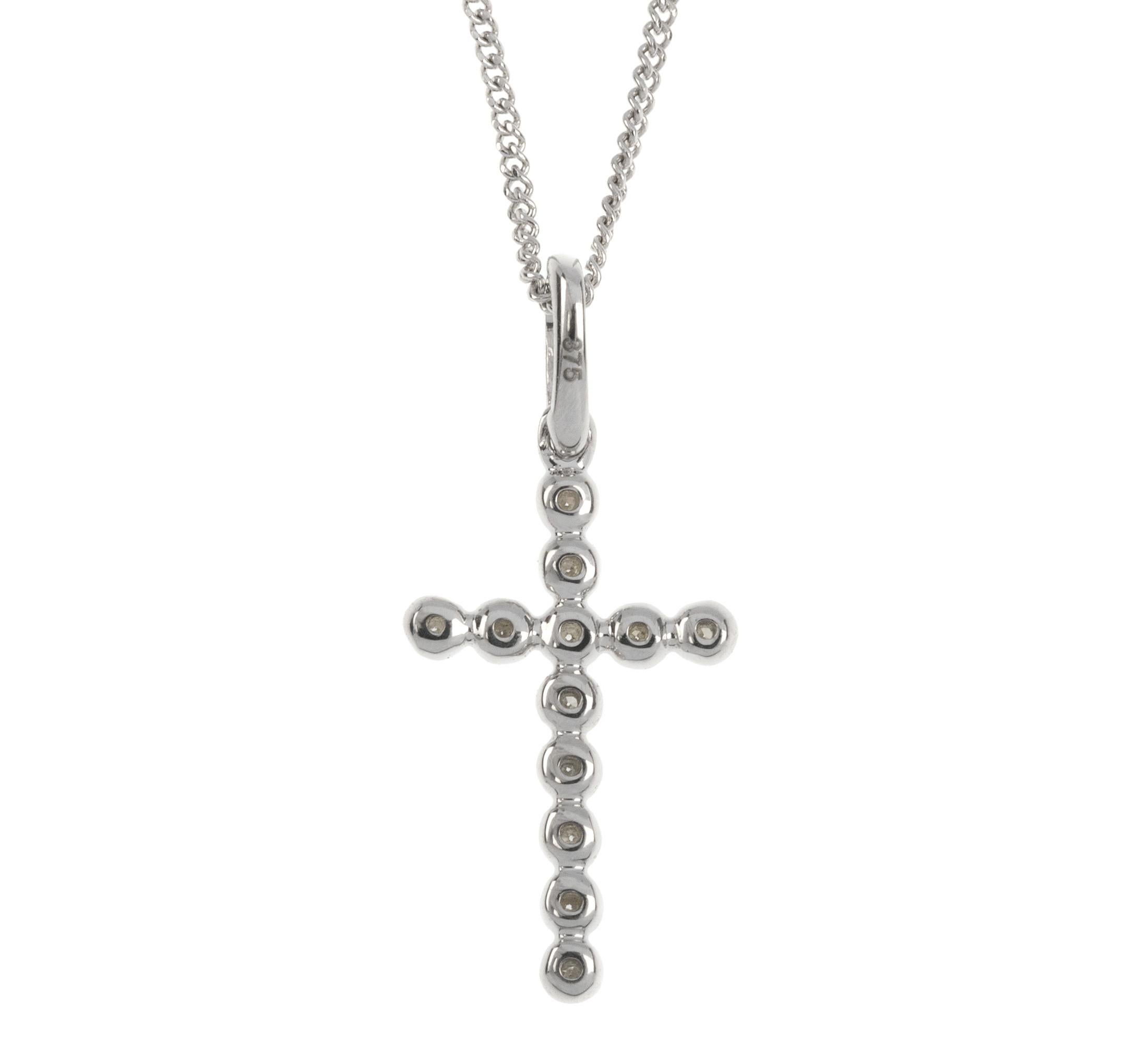 A simple and pretty white gold cross pendant set with a sprinkling of sparkling diamonds. Suspended from an 18