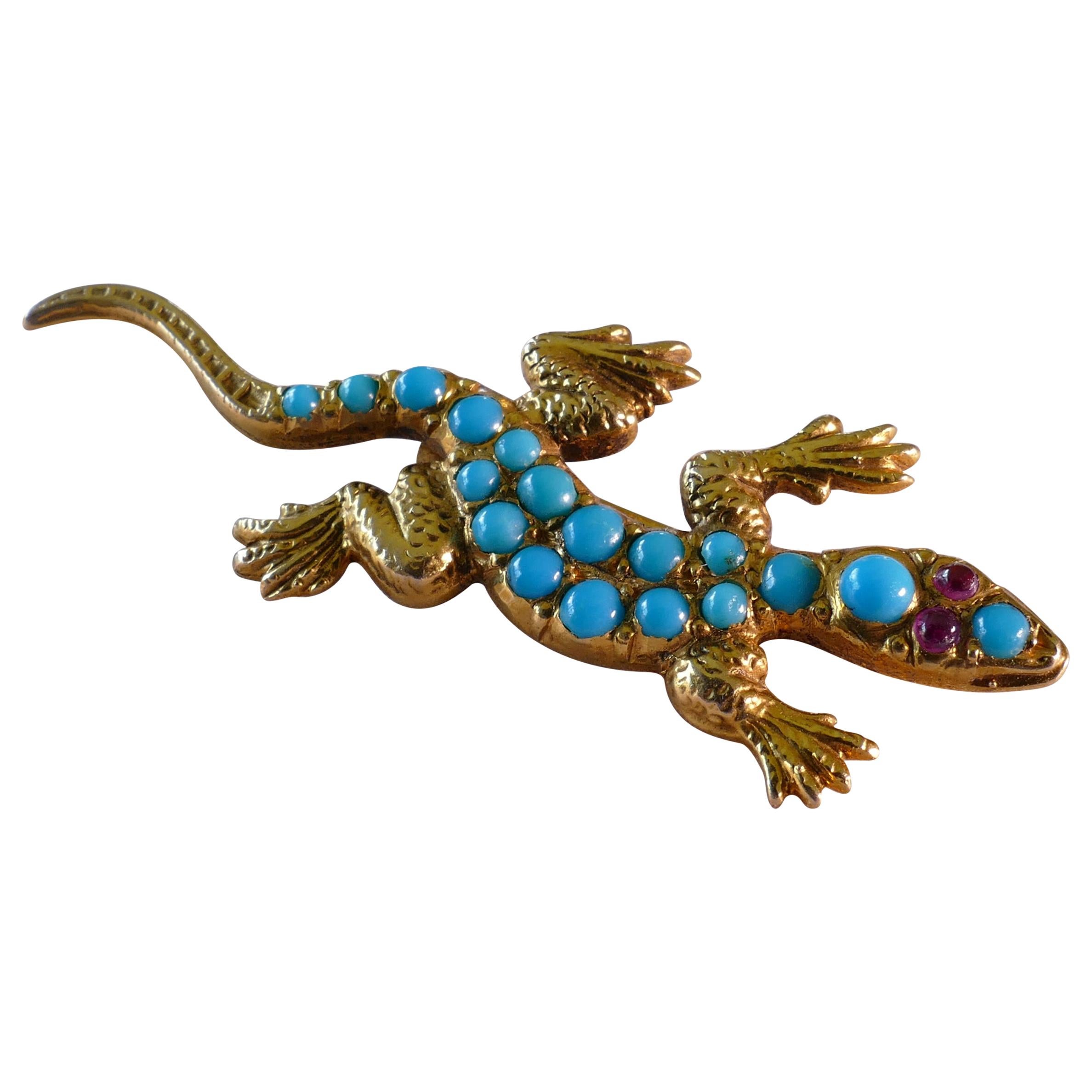 This beautiful piece of Antiquity, the Lizard Brooch, is comprised of 18 Cabochon Cut Turquoise Stones. 
The eyes are made of 2 round Cabochon Cut Rubies of a vivid pinkish red.
Valuation attached.