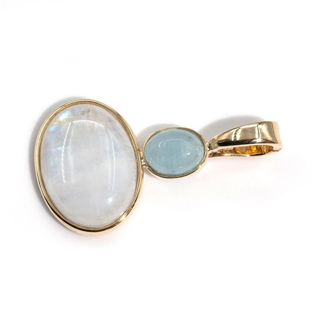 Crafted in 9 carat yellow gold is this charming vintage pendant featuring an alluring oval cabochon cut moonstone and a light blue oval cabochon chalcedony that sits above.  The gentle hues of blue are memorising making it easy to instantly fall in