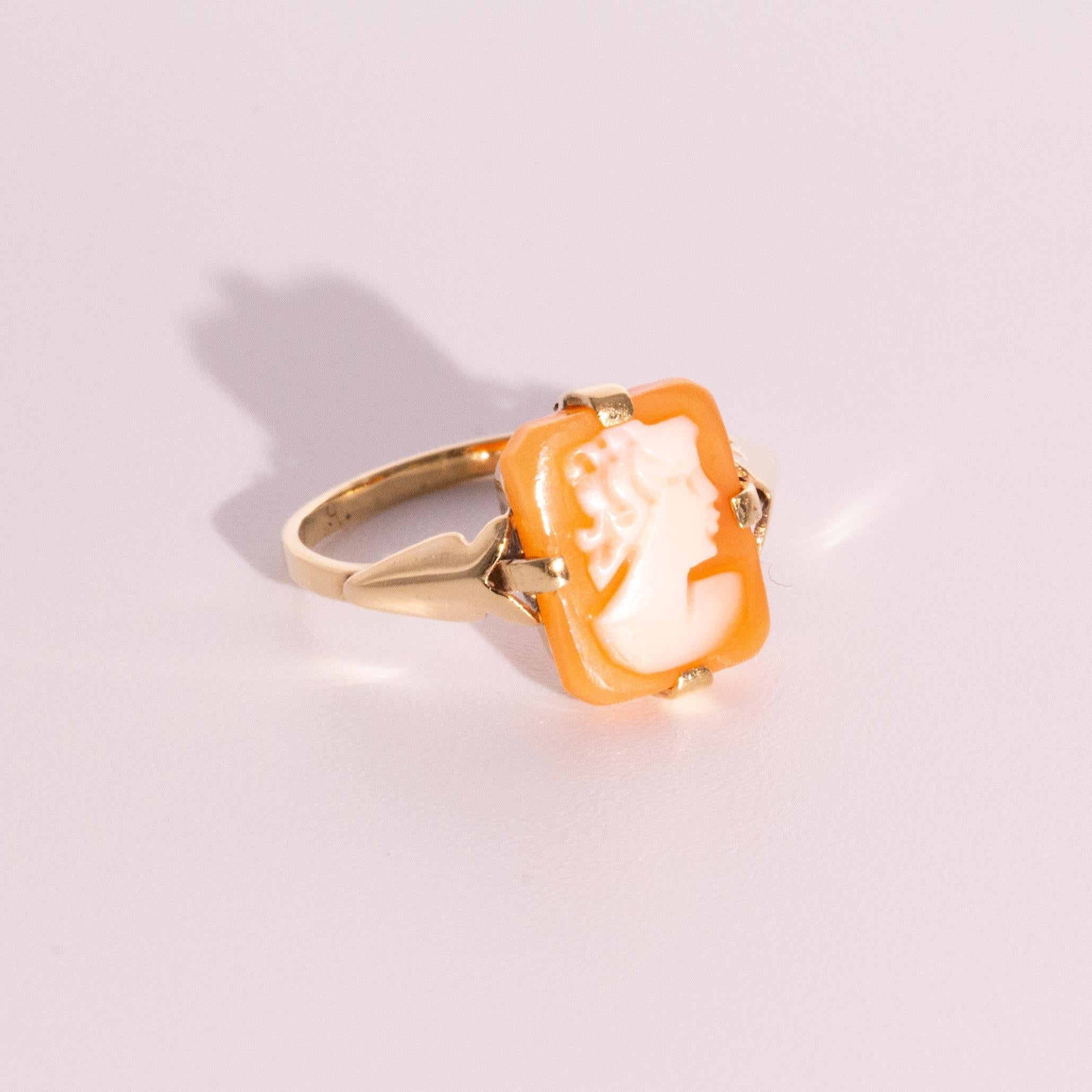Crafted in 9 carat yellow gold is this petite vintage ring that holds a rectangular shell cameo in subtle neutral tones.  This petite cameo is a little more unique than others as most commonly cameos are oval in shape. We have called her the Calvina