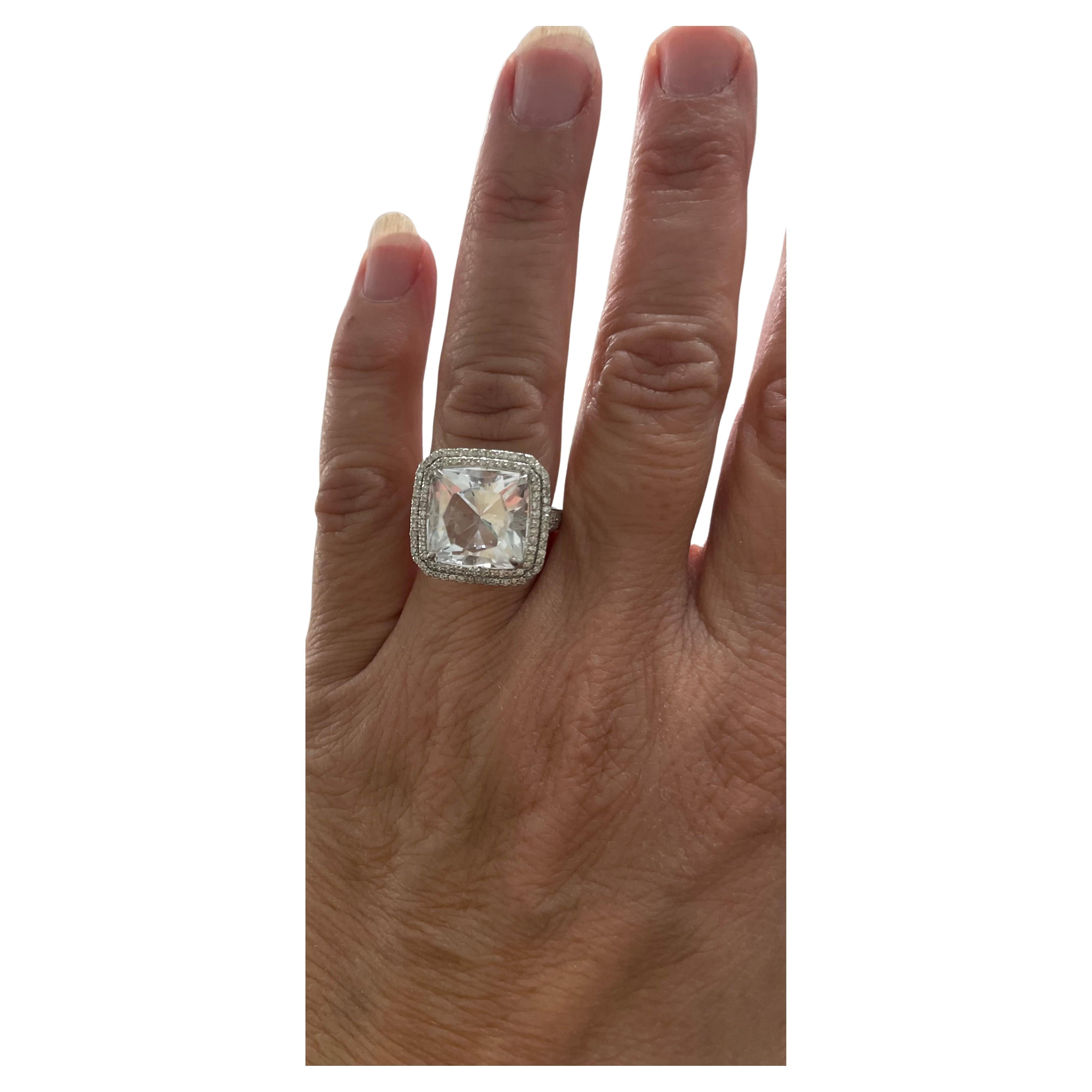 Description
Rare and desirable to collectors, this clear Petalite gemstone is framed with a double step rows of pave diamonds. The ring displays diamond quality for a fraction of the price. Item #R154

Materials and Weight
Petalite 8.9 carats, 13mm,