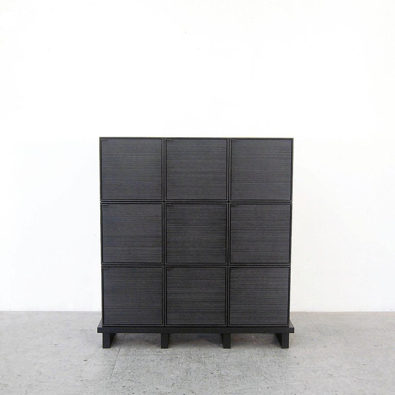 9 Cubes Cabinet by John Eric Byers
Dimensions: D115 x W38 x H115 cm
Materials: sawn + blackened + maple + ash

All works are individually handmade to order.

John Eric Byers creates geometrically inspired pieces that are minimal, emotional,