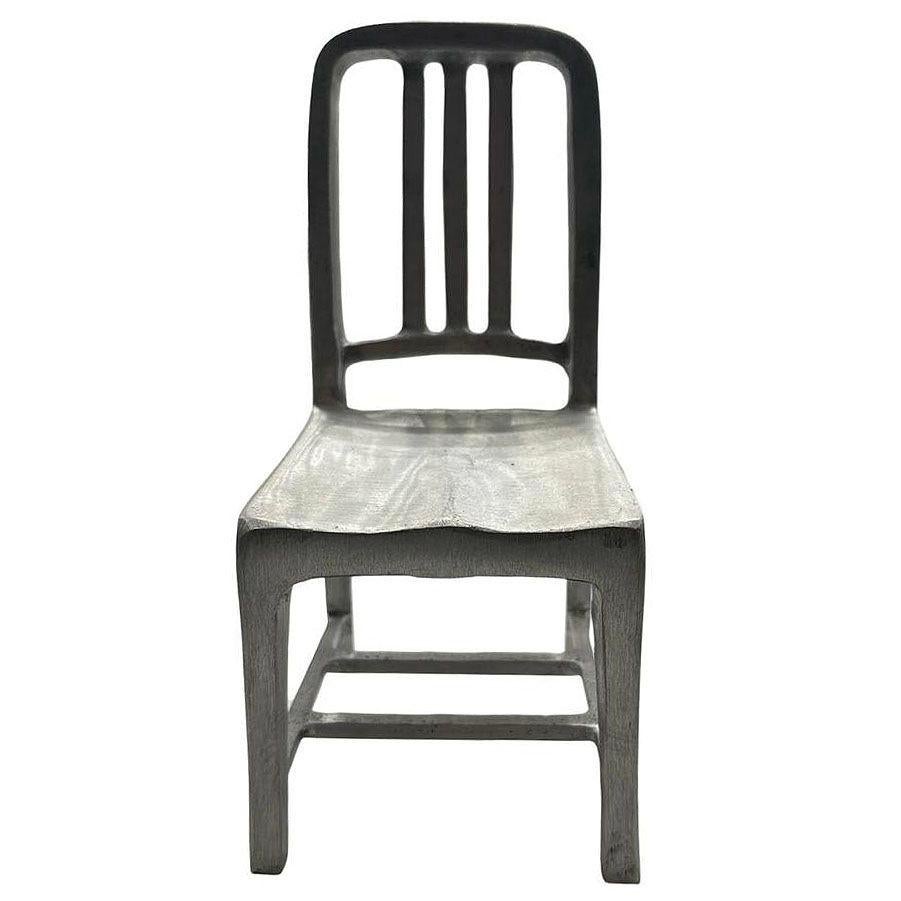 The Miniature Emeco model 1006 aluminum miniature chair sculpture salesmen sample is a detailed and compact replica of the iconic Emeco Navy Chair, originally designed in 1944 for use on U.S. Navy ships and submarines and later sold to the public