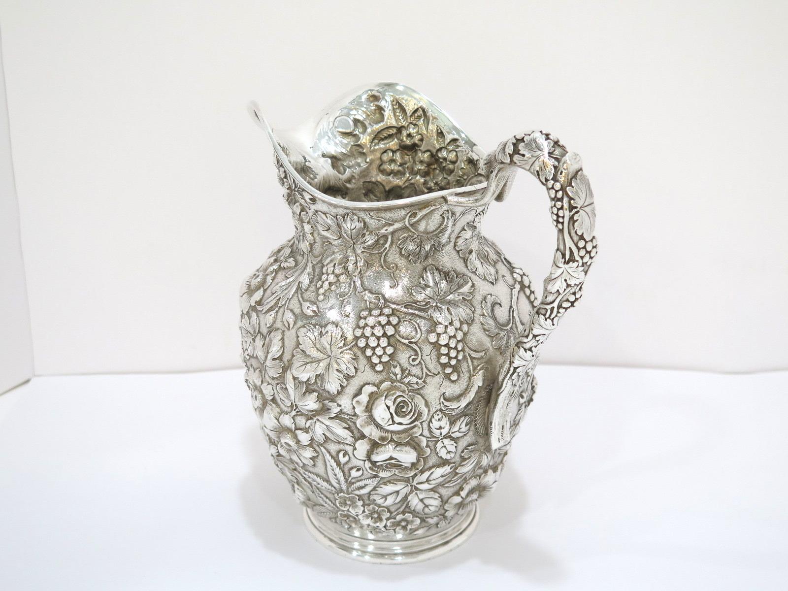 9 in - Sterling Silver Jenkins & Jenkins Antique Floral Repousse Pitcher In Good Condition For Sale In Brooklyn, NY