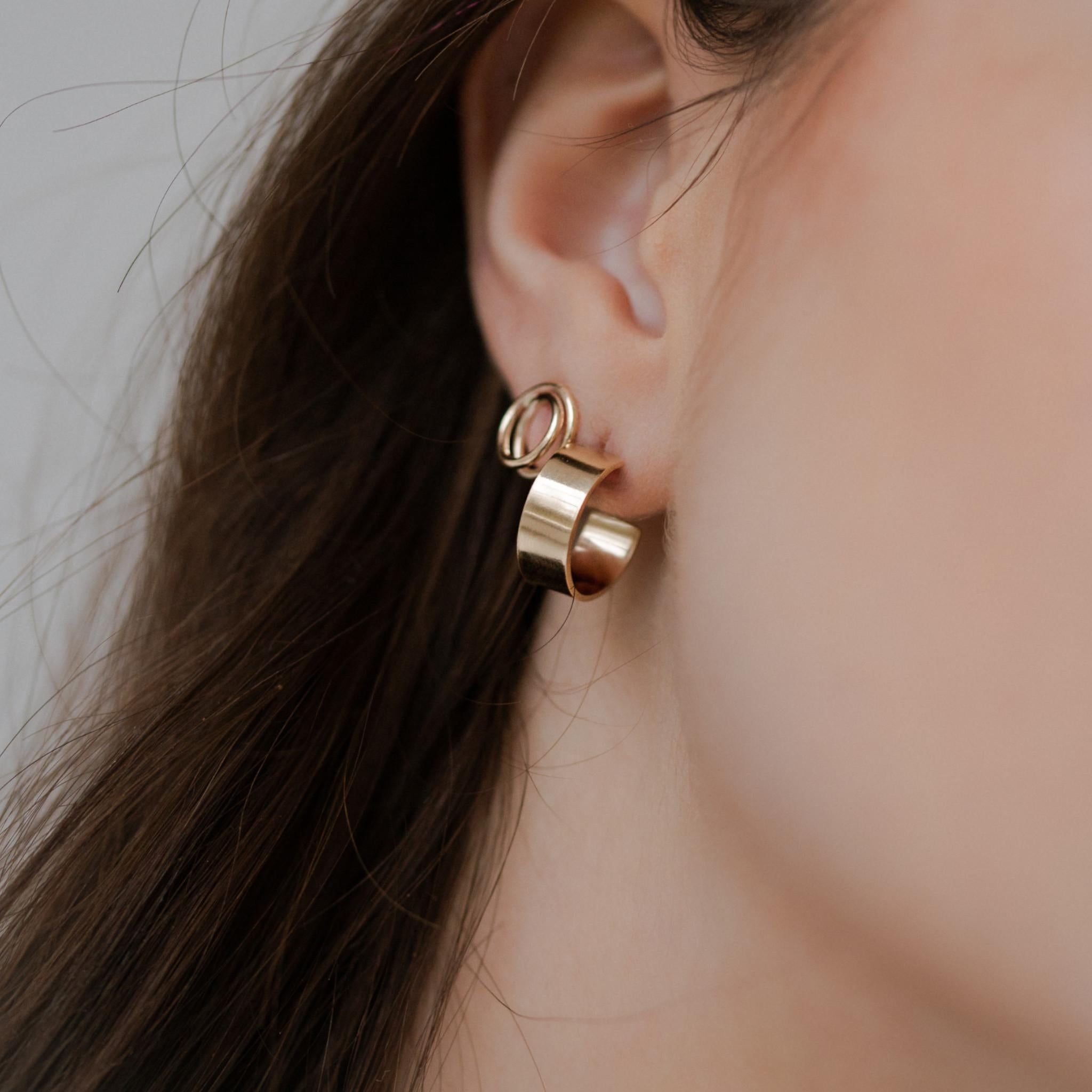 These contemporary minimalist hoop earrings are handmade to order using recycled 9 karat gold in our North London studio, and hallmarked by the London Assay Office.