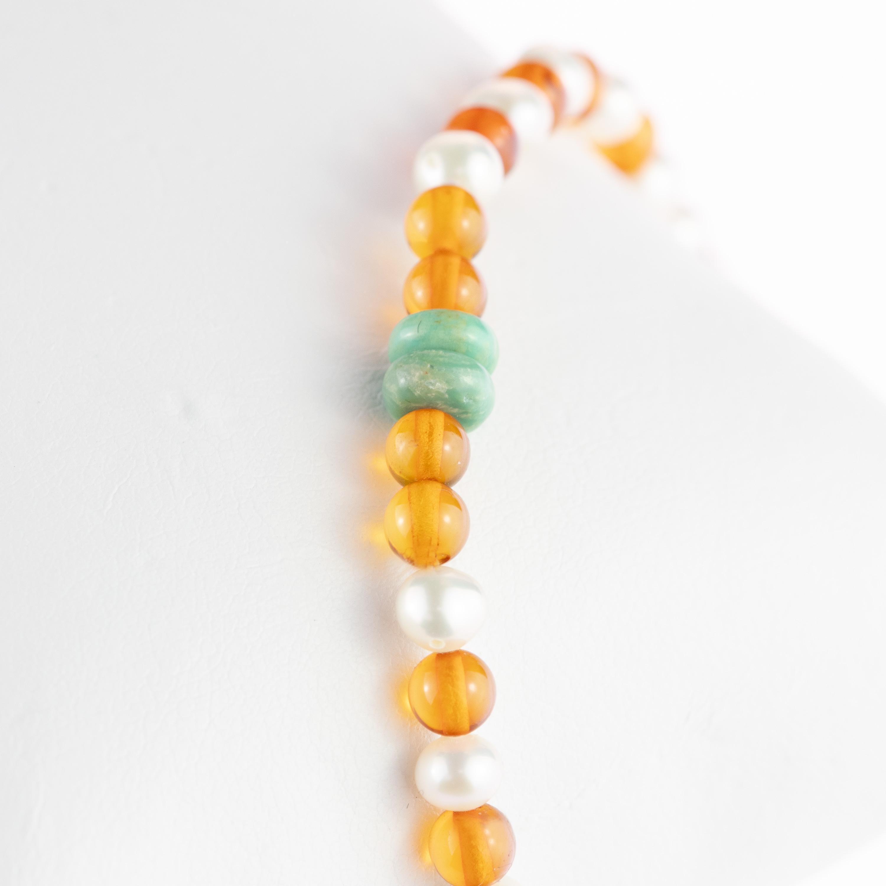 Baltic Amber and pearl jewelry for the entire family can help relieve a wide array of ailments, from infancy thru adulthood!. 9 karat yellow gold, 22 beads of freshwater pearls, 14 beads of baltic natural amber, 2 rondelle turquoise. Delivered in a