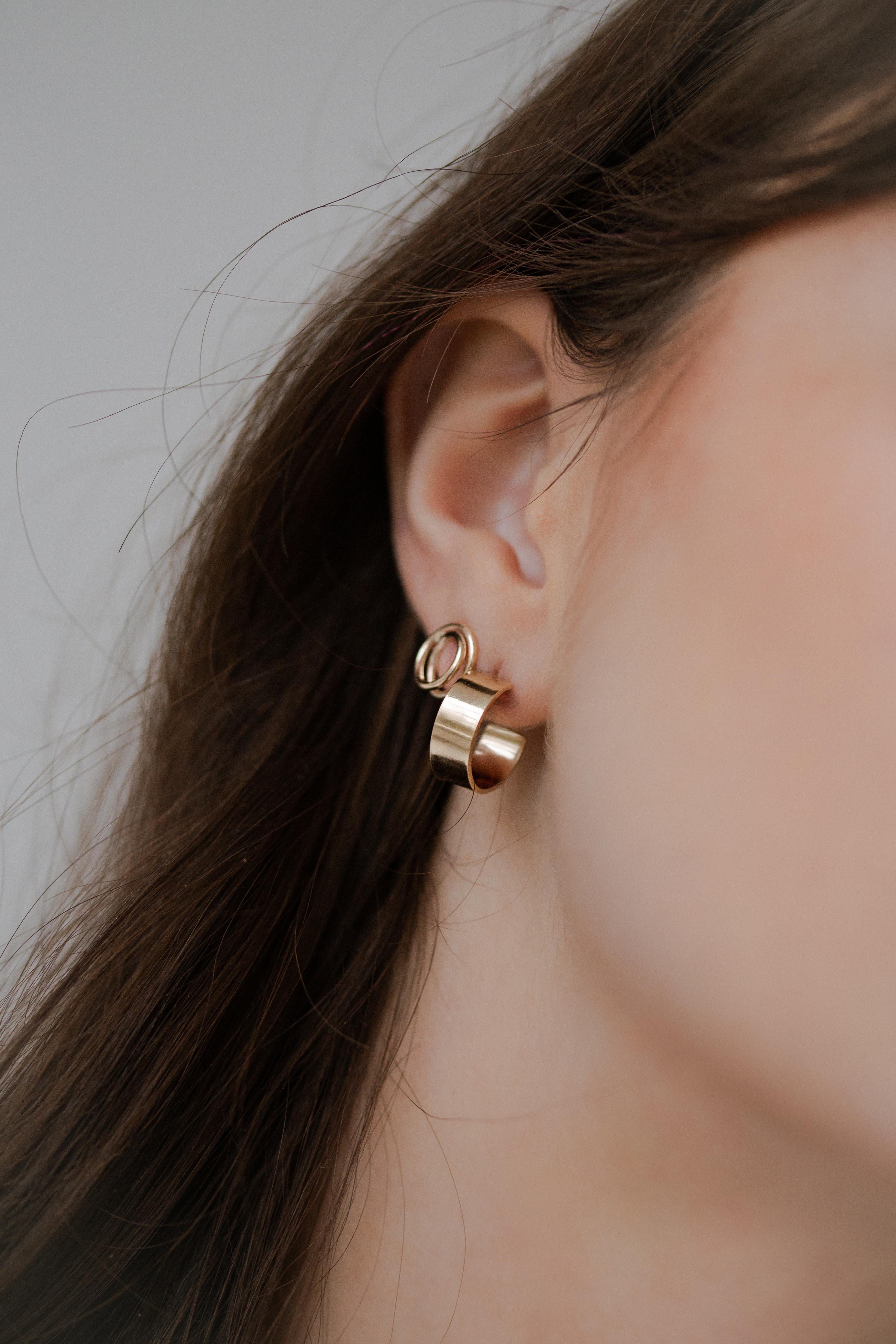 Inspired by the Everlasting Ring from the first All Day collection, the Mini Everlasting Stud Earrings form a continuous loop that sits on the ear lobe.

Handmade to order using recycled 9kt gold from our studio in North London and hallmarked by the