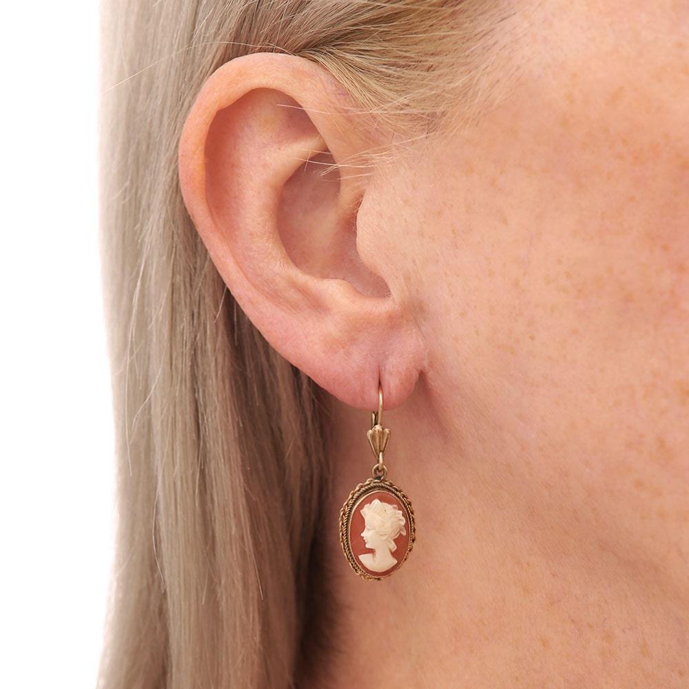 A pair of vintage 9 karat yellow gold cameo earrings showing a lady, this shell cameo is set in a rope edge mount with French fasteners. These pre-loved earrings measure 18 mm H x 13 mm W, being 34 mm L in total including the fastener. A small