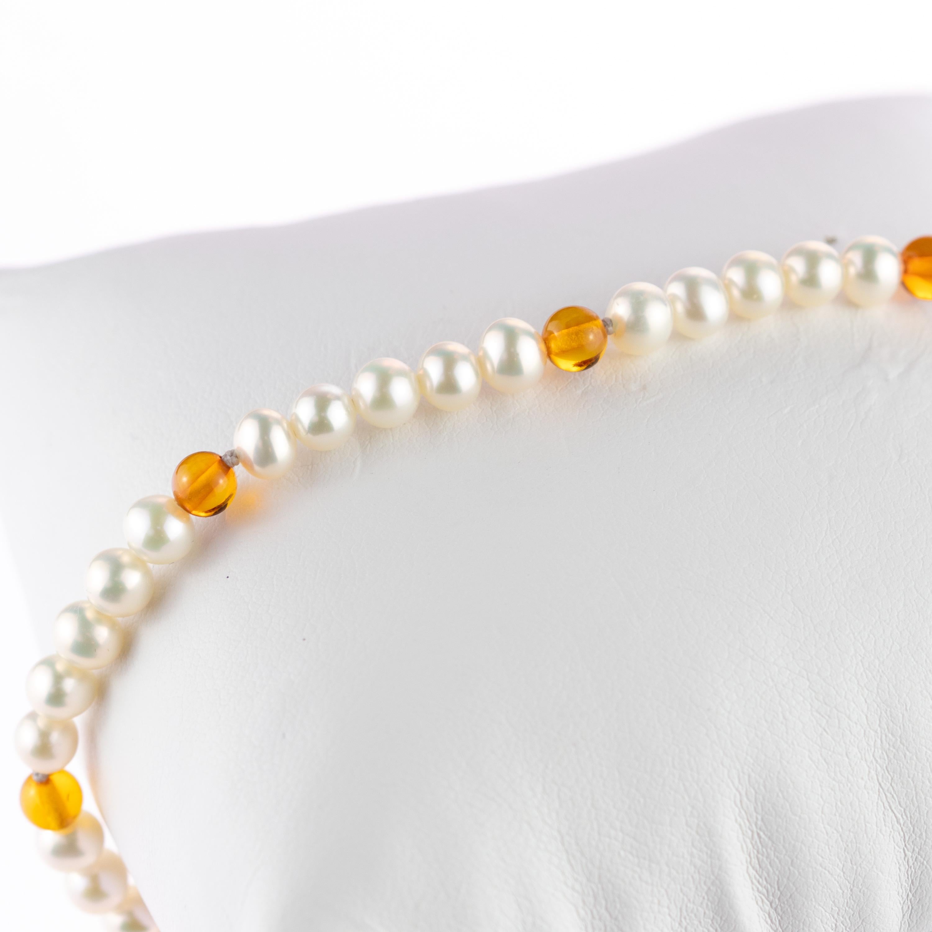 Baltic amber and luminous pearls scattered along a delicate bracelet. 9 karat rose gold, 27 beads of freshwater pearls and 10 beads of baltic natural amber.  A fresh look that highlights any outfit, day or night. For a passionate and energetic