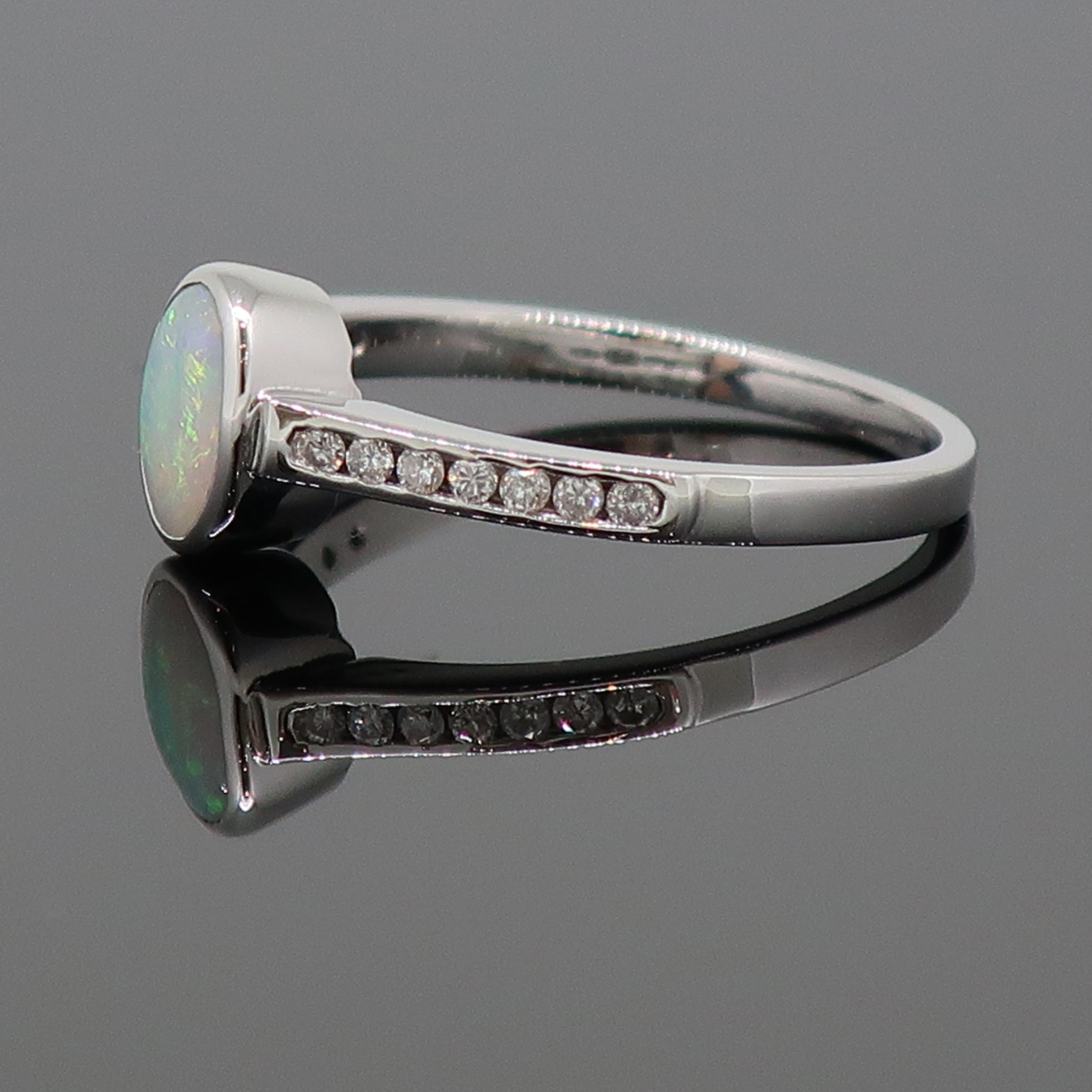 Contemporary 9 Karat White Gold Oval Opal Solitaire Ring with Diamond Shoulders For Sale