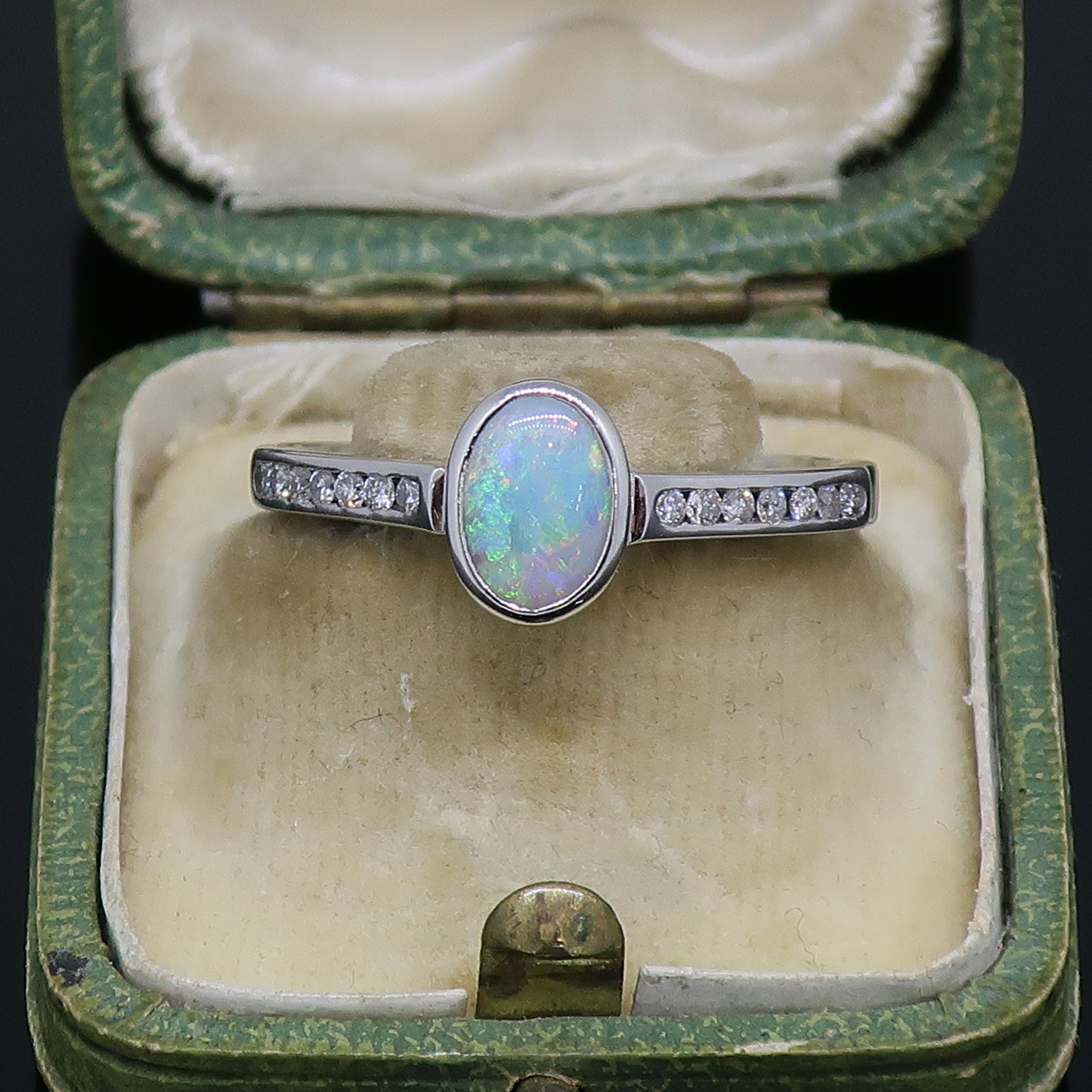 Women's 9 Karat White Gold Oval Opal Solitaire Ring with Diamond Shoulders For Sale