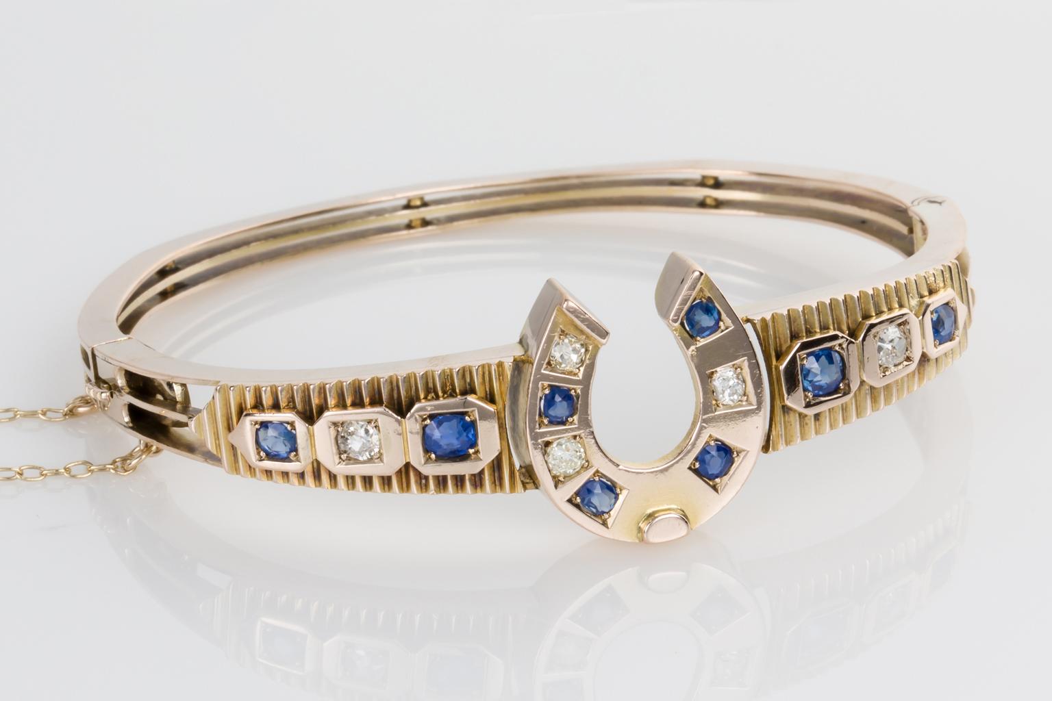 For good luck or for horse lovers, a vintage bangle that would make a lovely 18th or 21st gift. Set with 8 pretty blue sapphires and 5 old European cut diamonds mounted in 9 karat yellow gold. The bangle is hinged so it is easy to put on and take