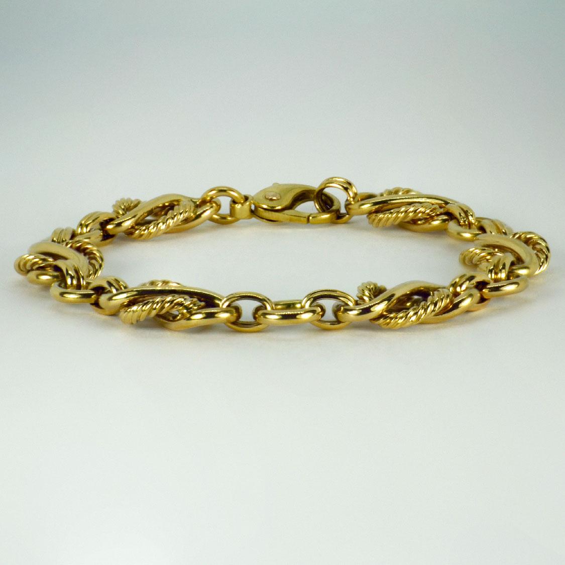 A 9 karat (9K) yellow gold fancy link bracelet. Stamped 375 and 9ct for 9 karat gold with hallmarks for Birmingham 1986 and maker’s mark JC&S. 8” long.

Dimensions: 20.5 x 1.2 cm
Weight: 27.11 grams
