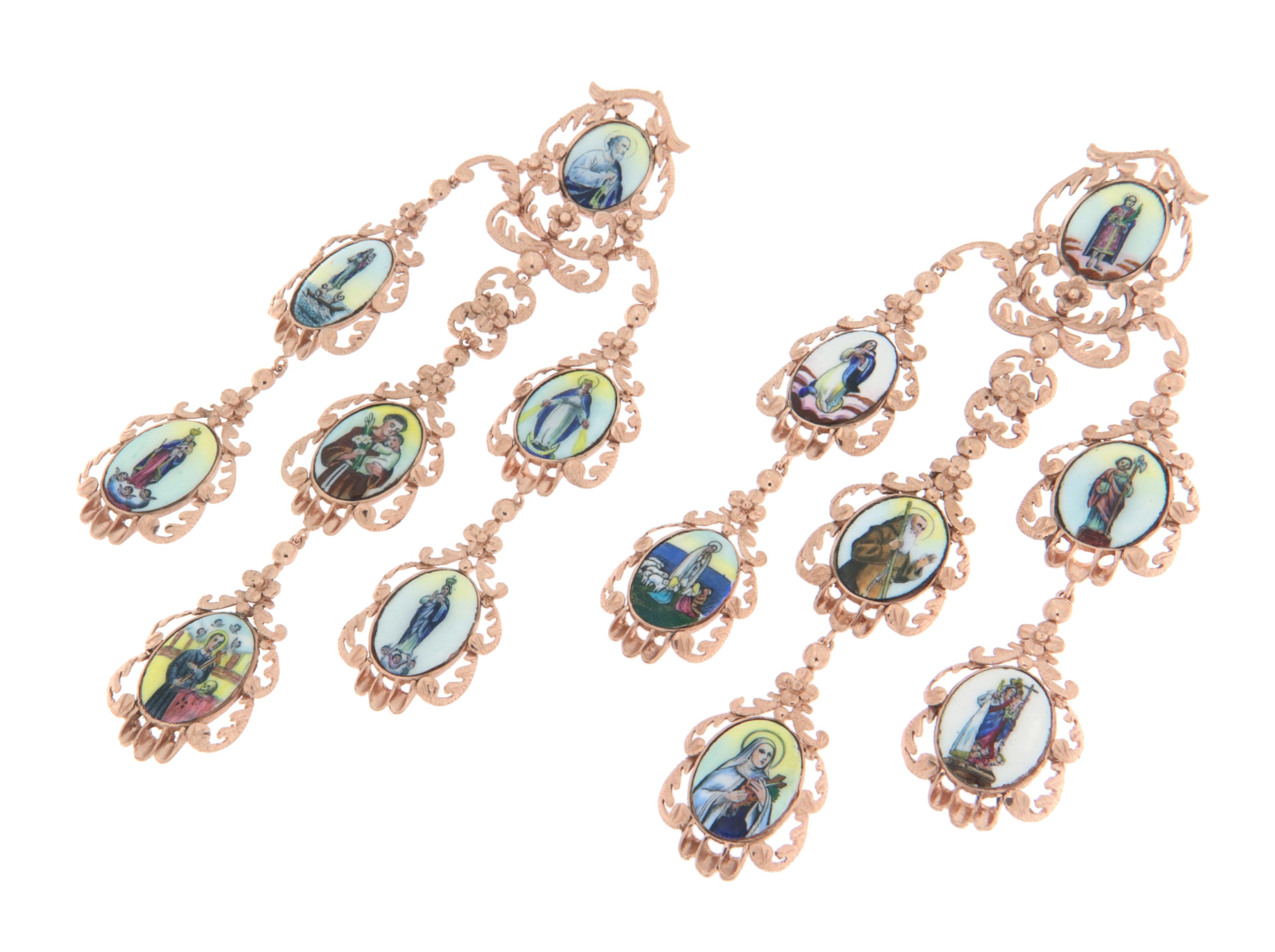 These elegant 9k yellow gold drop earrings are a tribute to sacred art and masterful craftsmanship. Featuring a cascading design, they showcase a series of hand-painted sacred figures on small enameled panels, set within delicate decorative gold