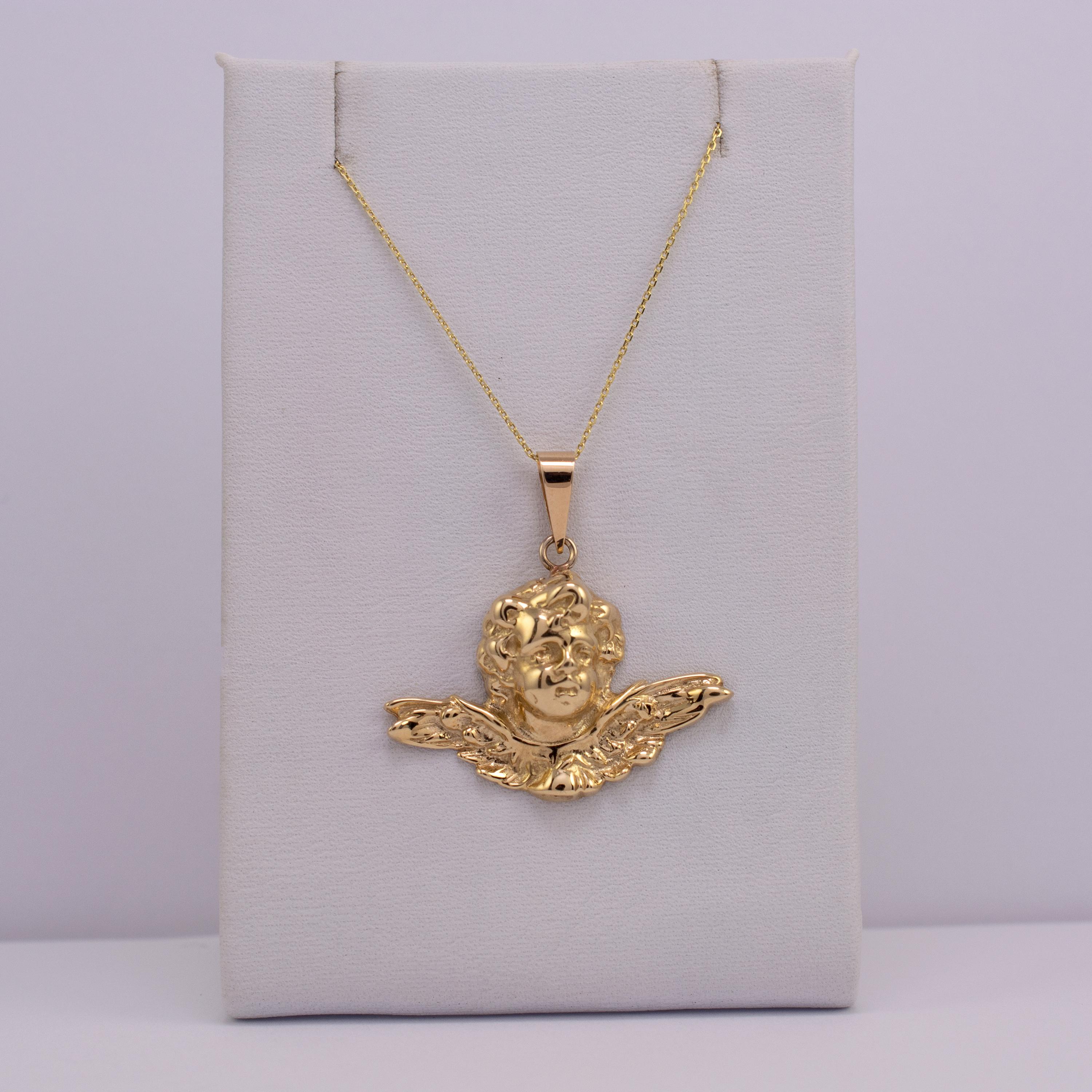 This graceful solid 9k gold winged Cherub pendant comes complete with 16-inch 9k gold chain.

The piece is superbly crafted, depicting winged cherub in smooth polished gold.

Full Birmingham assay hallmarks are engraved to the reverse side.

Offered