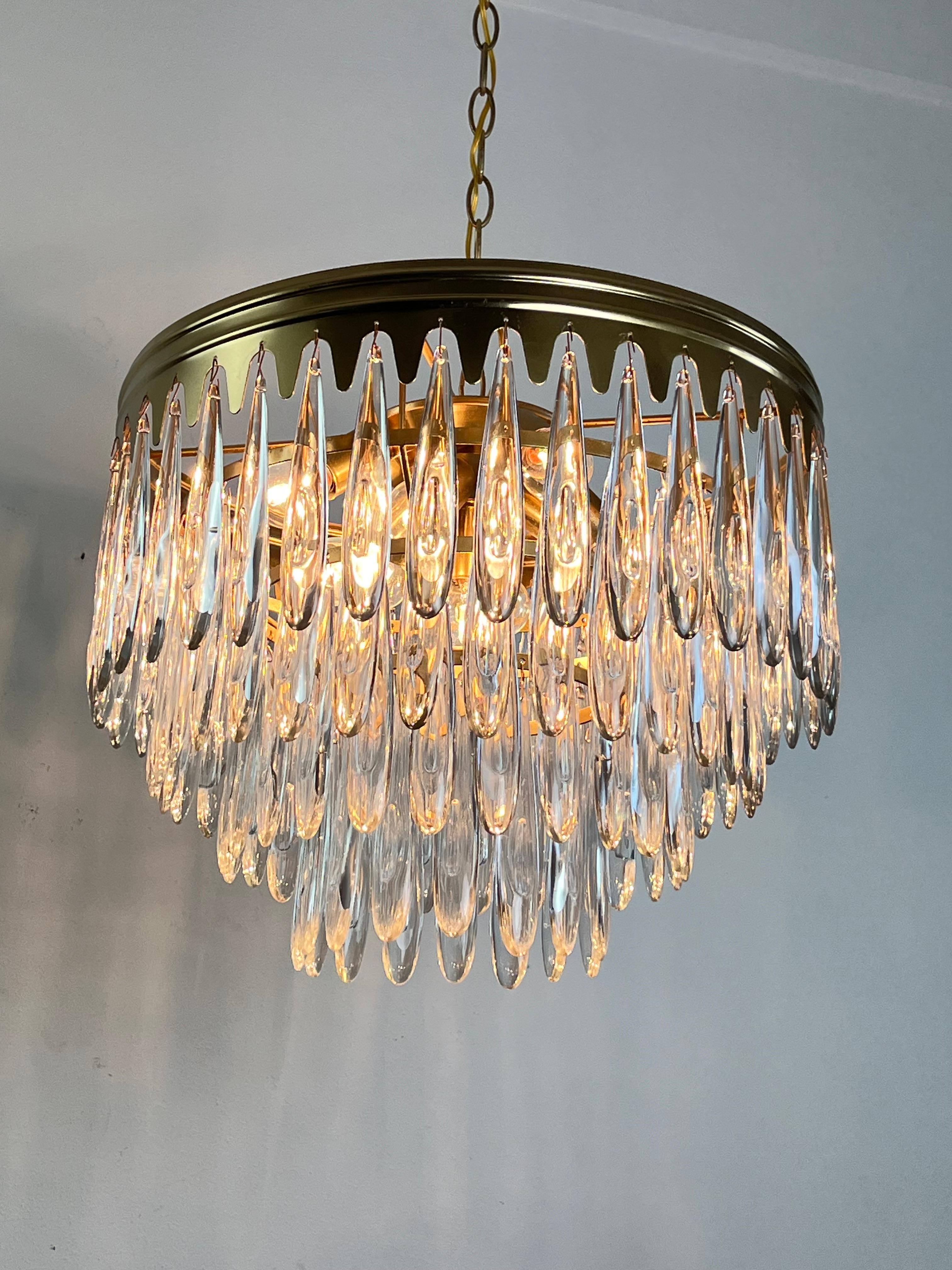 9-light Mid-Century Murano glass chandelier 1960s 
The diameter is 45 cm. The height is 40 cm (100 cm including the chain).
Golden metal structure, found in a noble apartment.
E16 lamps, good condition.