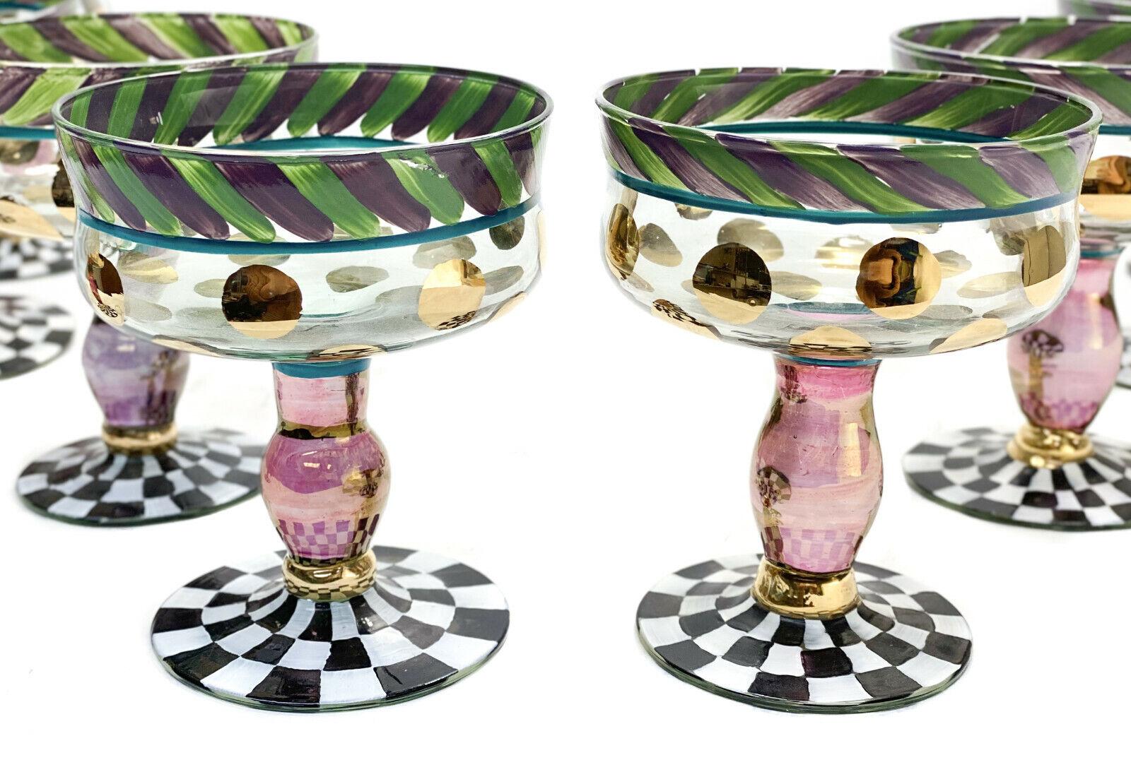 9 MacKenzie childs glass champagne saucers sherbet goblets in circus everydae

Hand painted green and purple stripes to the top rim with a black and white checkered base. Large gold polka dots to the body with a cranberry red gold iridescent stem.
