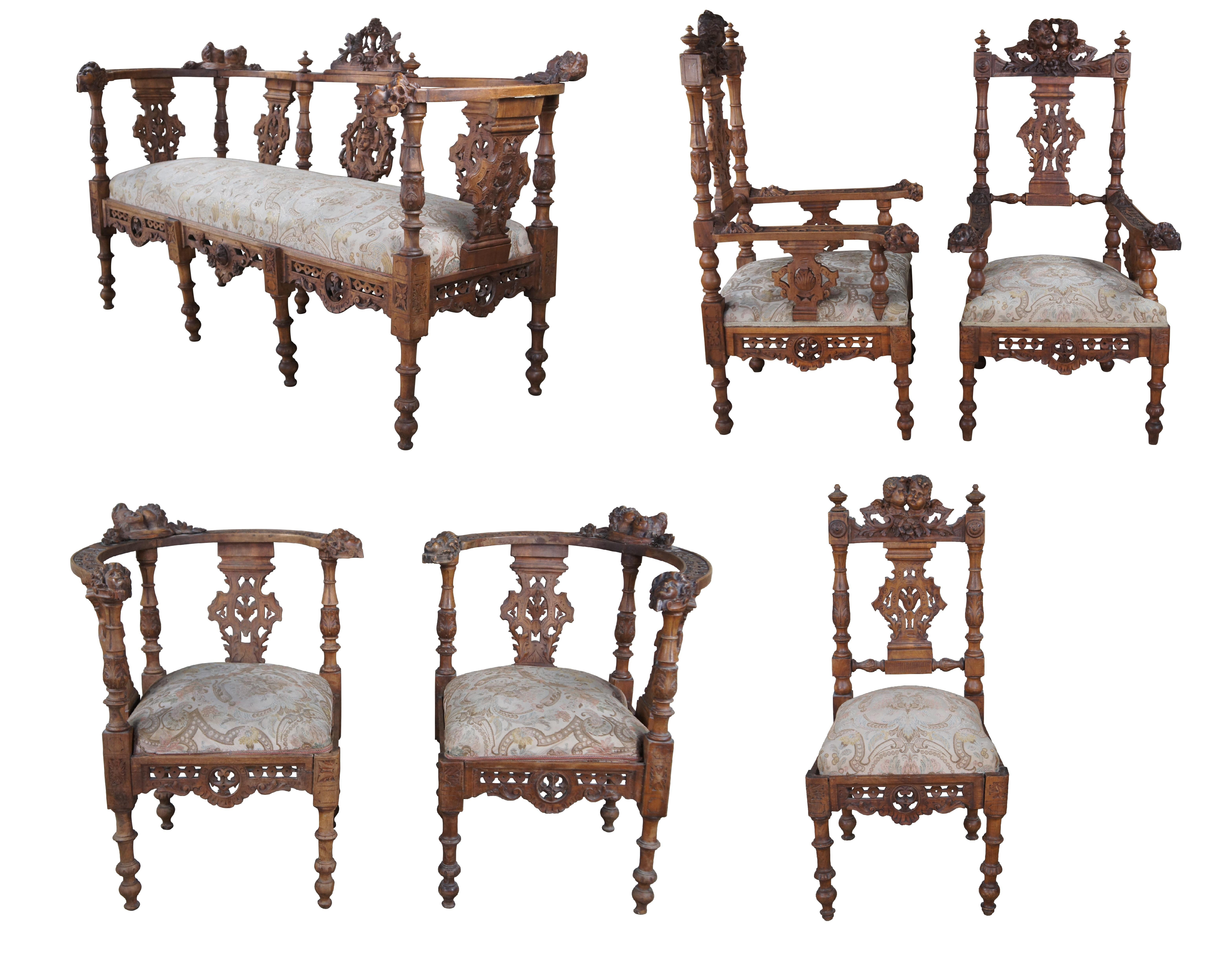Set of 9 pieces of antique Italian Neo-Renaissance furniture, circa 1870s, including 2 side chairs, 2 corner chairs, 2 arm chairs, a parlor settee / loveseat, writing table, and drop front / secretary desk. Made of walnut featuring Neoclassical