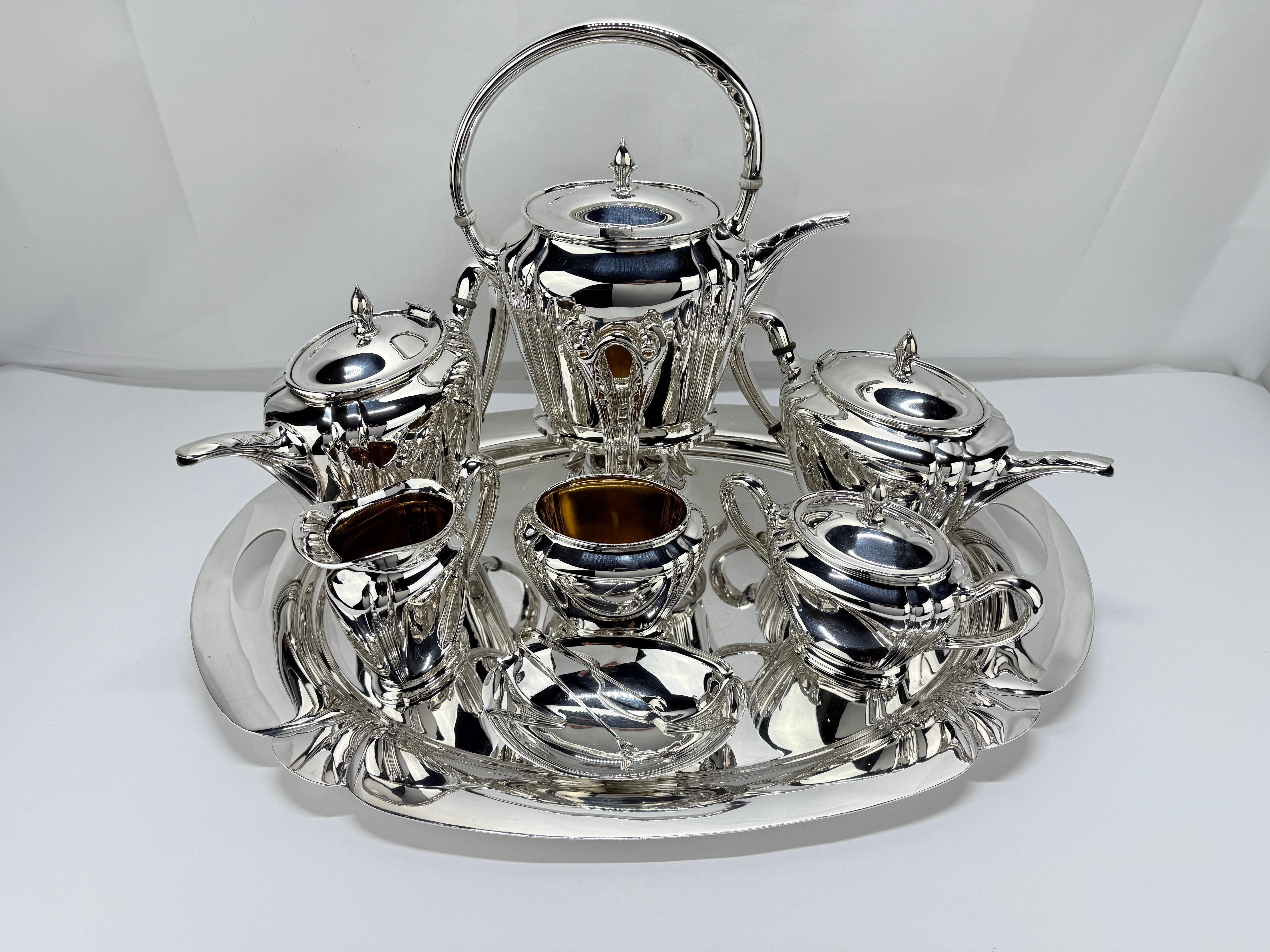 This distinguished nine-piece tea and coffee service, crafted by the International Silver Company, epitomizes the height of American silver artistry from the early 20th century. Designed in the iconic Orchid pattern, this set reflects the luxurious