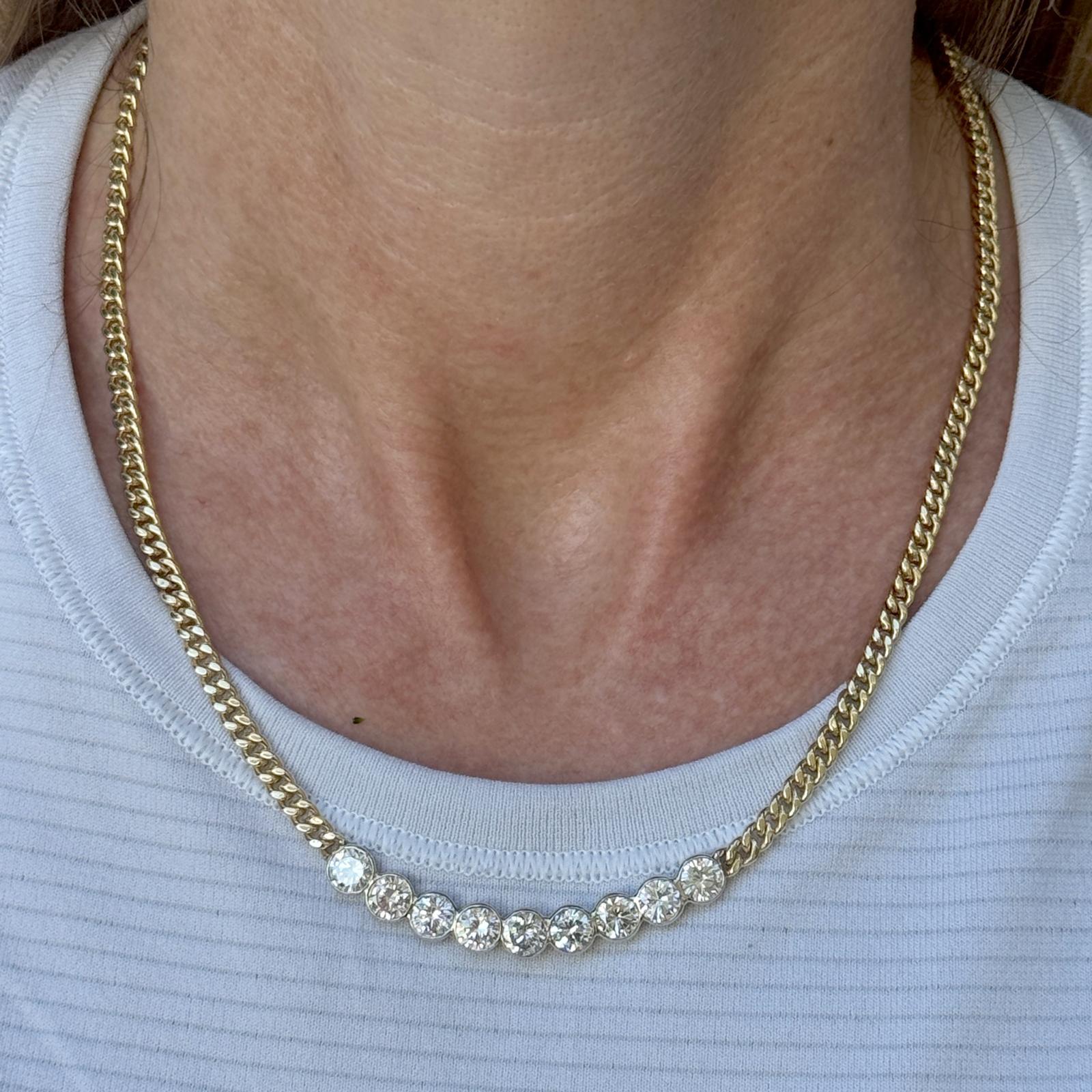 A breathtaking statement of elegance, this two-tone 14 karat gold diamond bar necklace showcases nine exceptional round brilliant-cut diamonds, each weighing approximately 0.50 carats for a total diamond weight of 4.50 carats. The diamonds, graded
