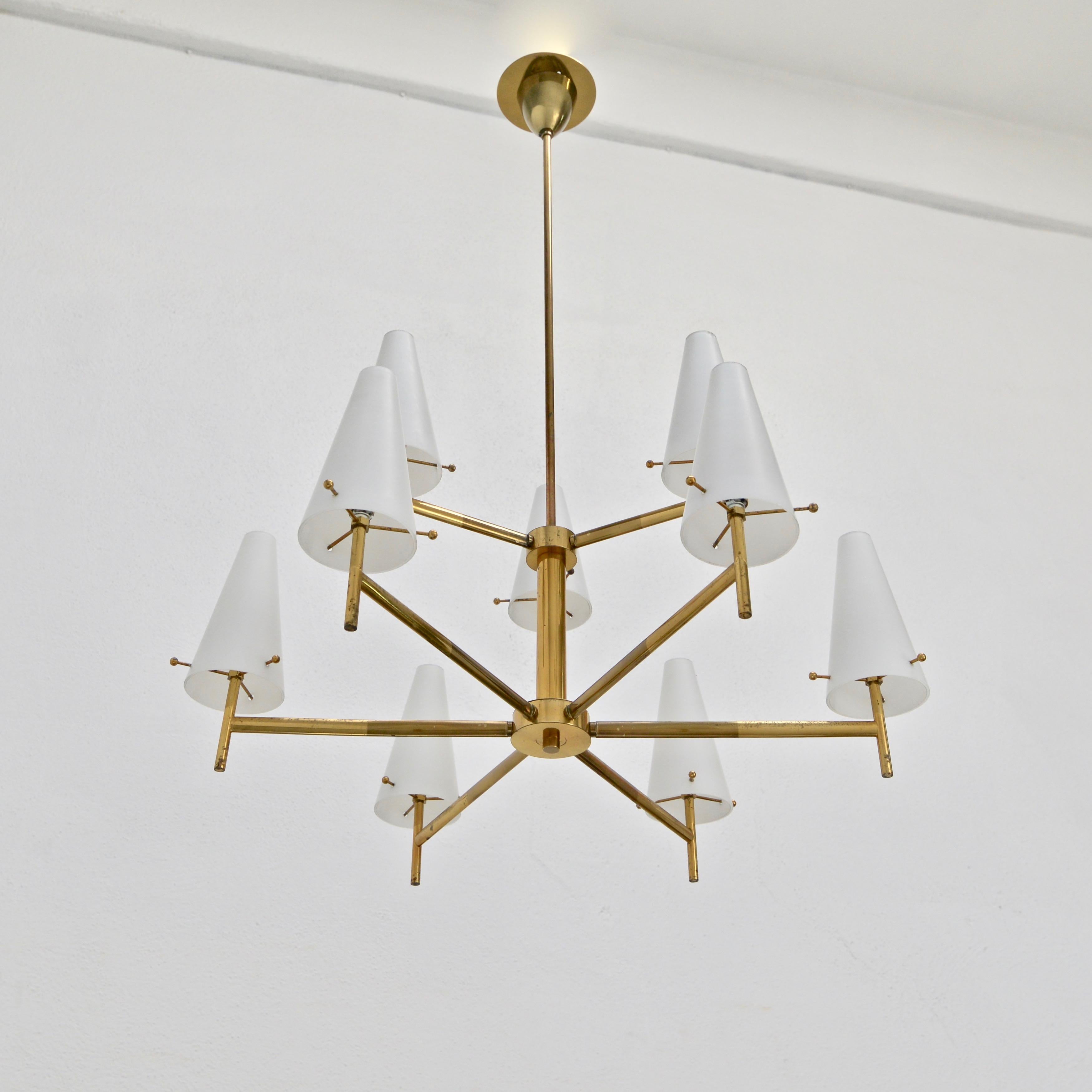 A beautiful classical midcentury 1950s Italian glass and naturally aged brass chandelier 9 glass shades with E12 candelabra based sockets per shade. Wired for use in the US. Light bulbs included with order.
Measurements:
OAD: 37” 
Diameter