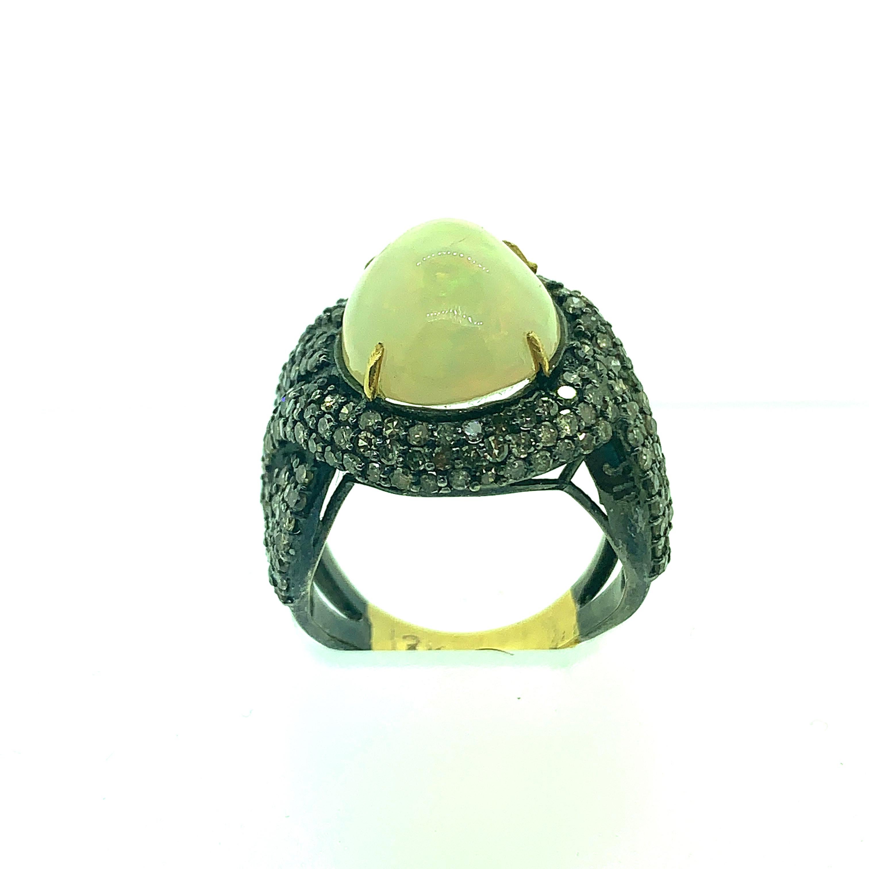 9 Size 6.10 ct Opal and 1.83 ct Champagne Diamond Ring set in Oxidized Sterling Silver with half shank in 18 K Gold. The fire in the opal is good to see with your eyes. The moment the ring touches the skin the fire in the opal can be seen