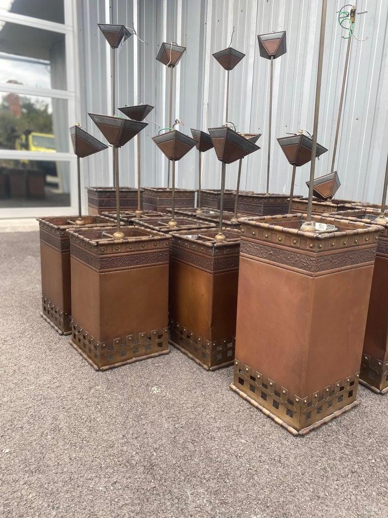 Beautiful grouping of 9 tall vintage pendant lights by Isaac Maxwell. Two of the lights have patina on one side. 10