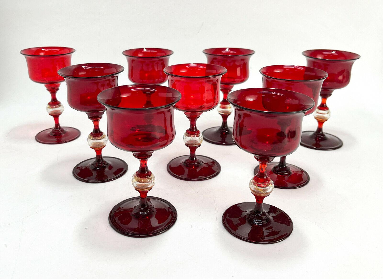 9 Venetian Murano cranberry red & gold fleck art glass sherry wine goblets, Attributed to Salivati. Blown stemware comprising of 4-5 pieces with a clear gold fleck bulb to the stem. Polished pontil to the underside.

Additional