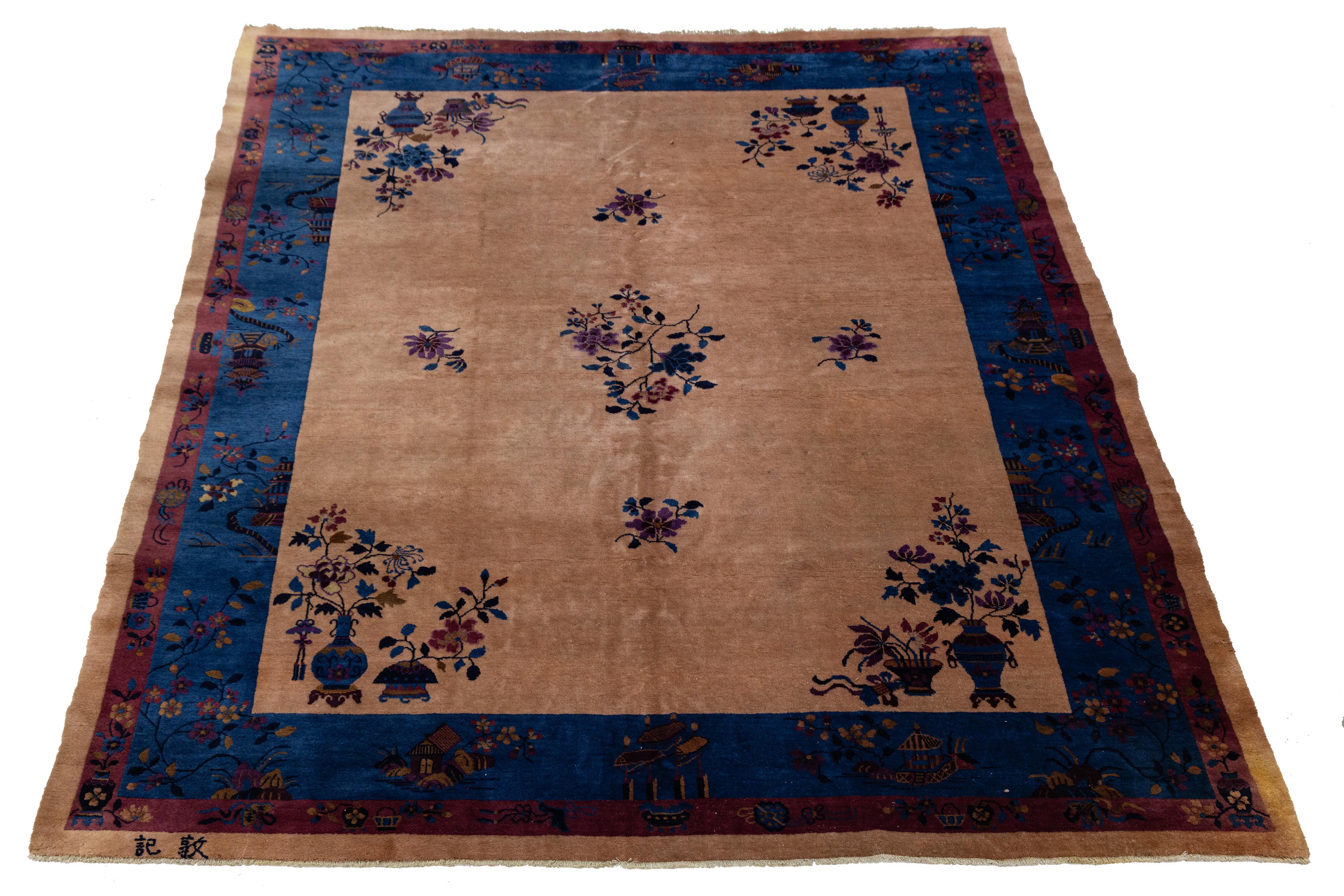 Dieser exquisite antike chinesische Art-Déco-Teppich ist aus hochwertiger Wolle handgeknüpft. Der tiefbraune Hintergrund ist mit einem blauen und violetten Blumenmuster verziert, das elegant von einer passenden marineblauen Bordüre eingerahmt