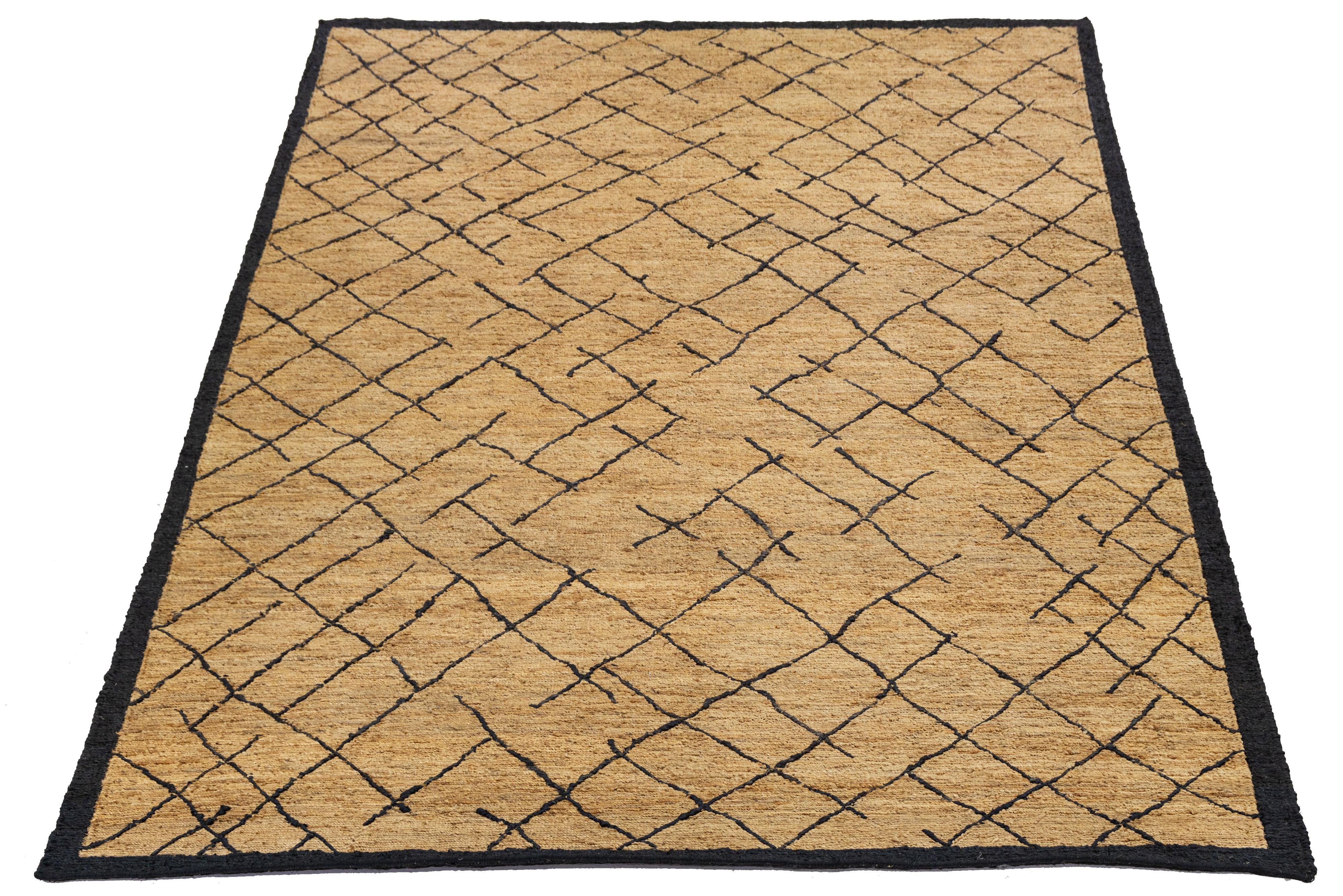 This beautiful modern Soumak hand-knotted Jute rug has a golden-tan field. It features brown accents in a gorgeous all-over geometric design.

This rug measures 9' x 12'3