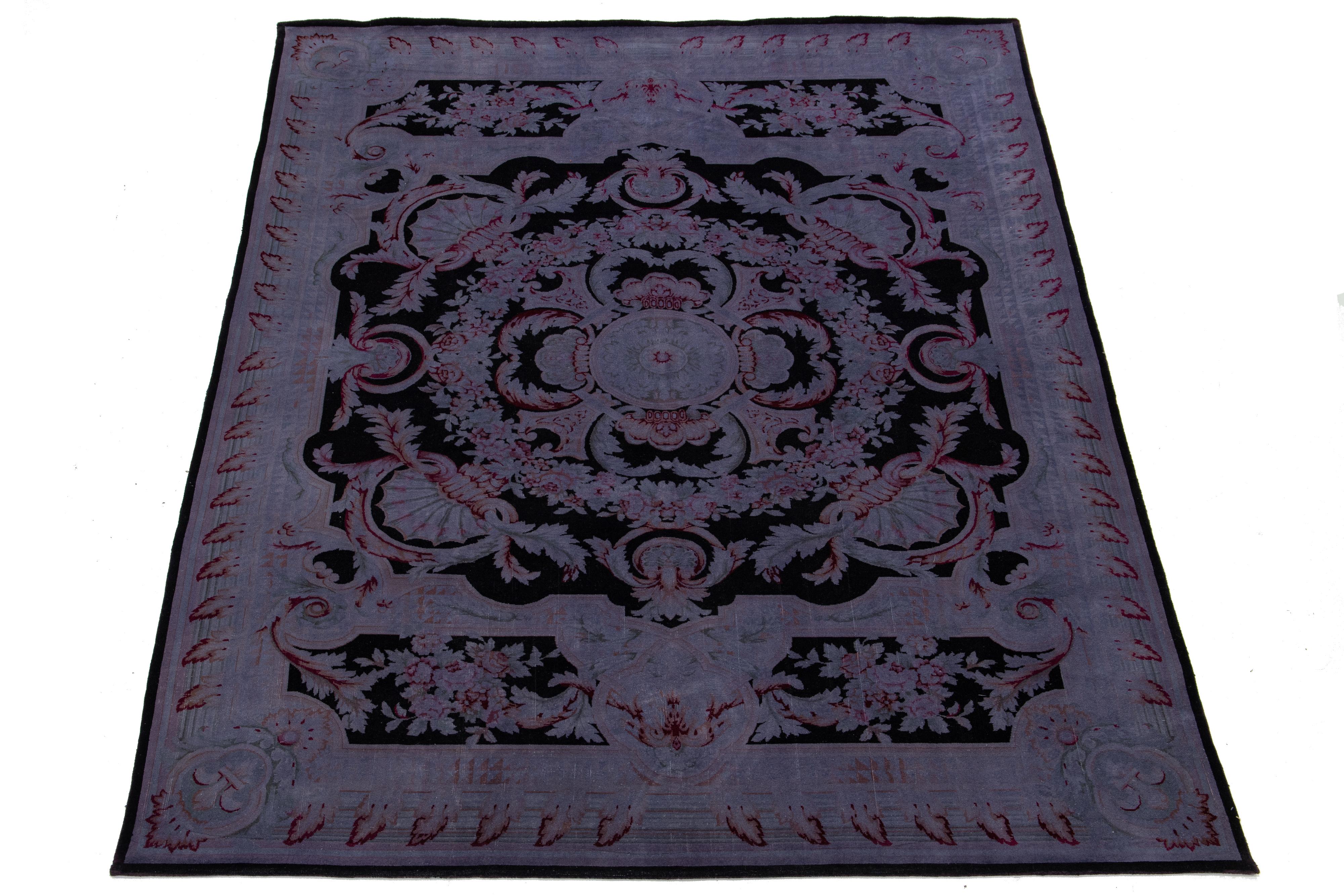 This transitional overdyed Persian wool rug showcases a beautiful light purple color field with delightful floral accents in black, red, green, and orange.

This rug measures 8'10