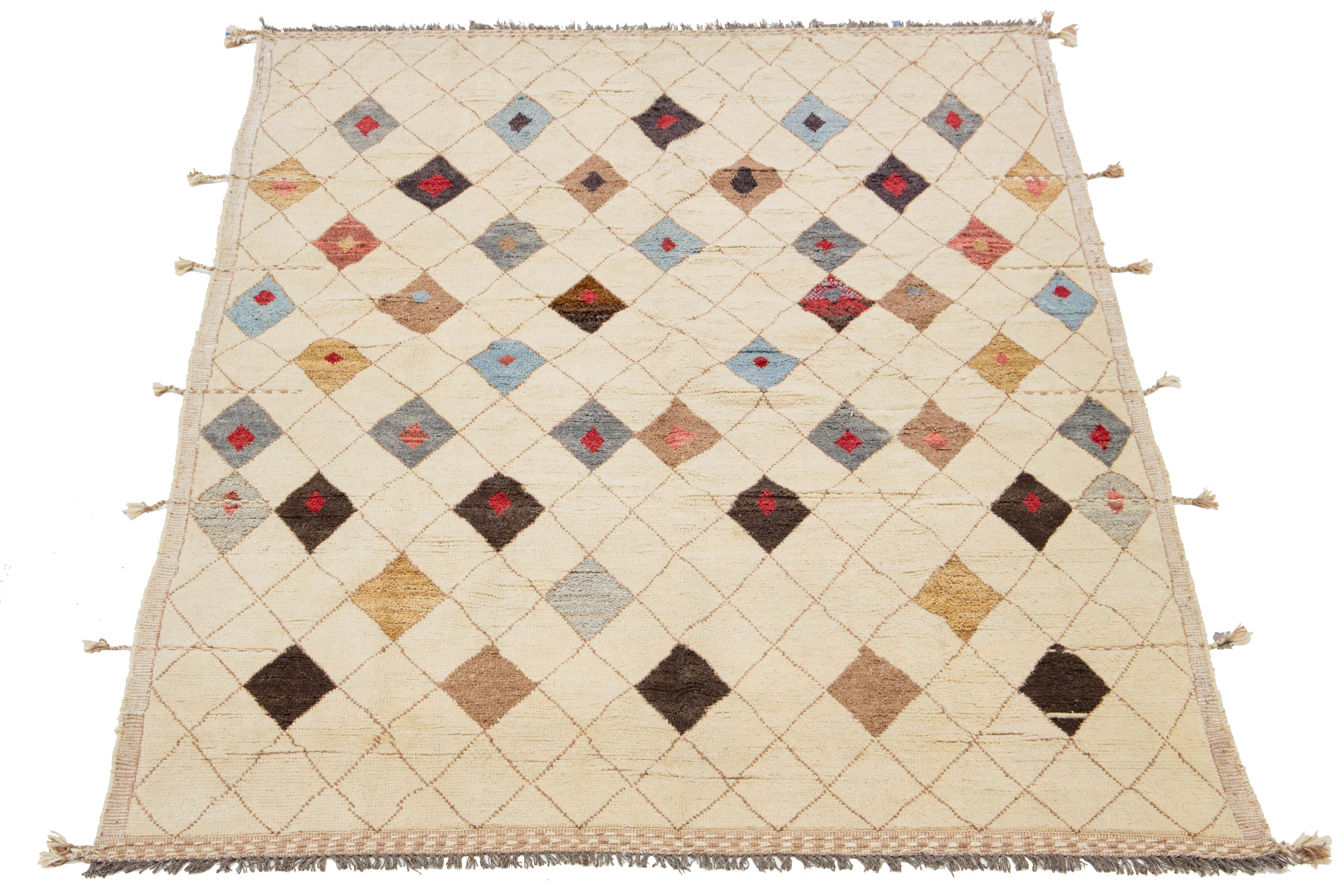 This handcrafted, contemporary Moroccan-style wool rug features a stunning beige background that seamlessly blends traditional craftsmanship with modern design elements in vibrant, multicolored hues. The intricately woven tribal patterns add depth