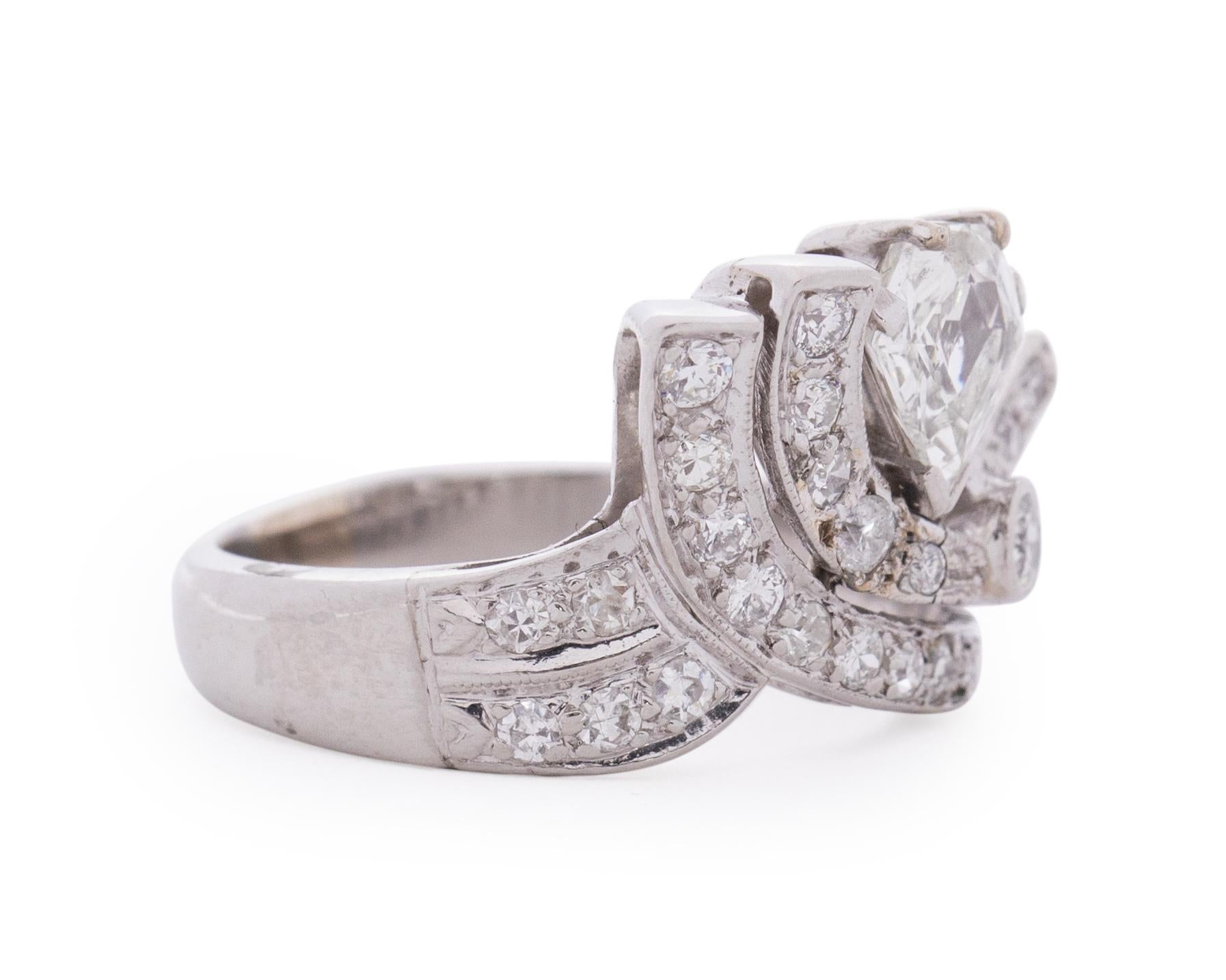 Item Details: 
Ring Size: 6.5
Metal Type: Platinum [Hallmarked, and Tested]
Weight: 7.9 grams

Center Diamond Details:
Weight: .90 Carat
Cut: Antique Shield Cut
Color: I
Clarity: SI2

Side Stones: Natural Diamonds, Old European Cut, .20cttw, G-H