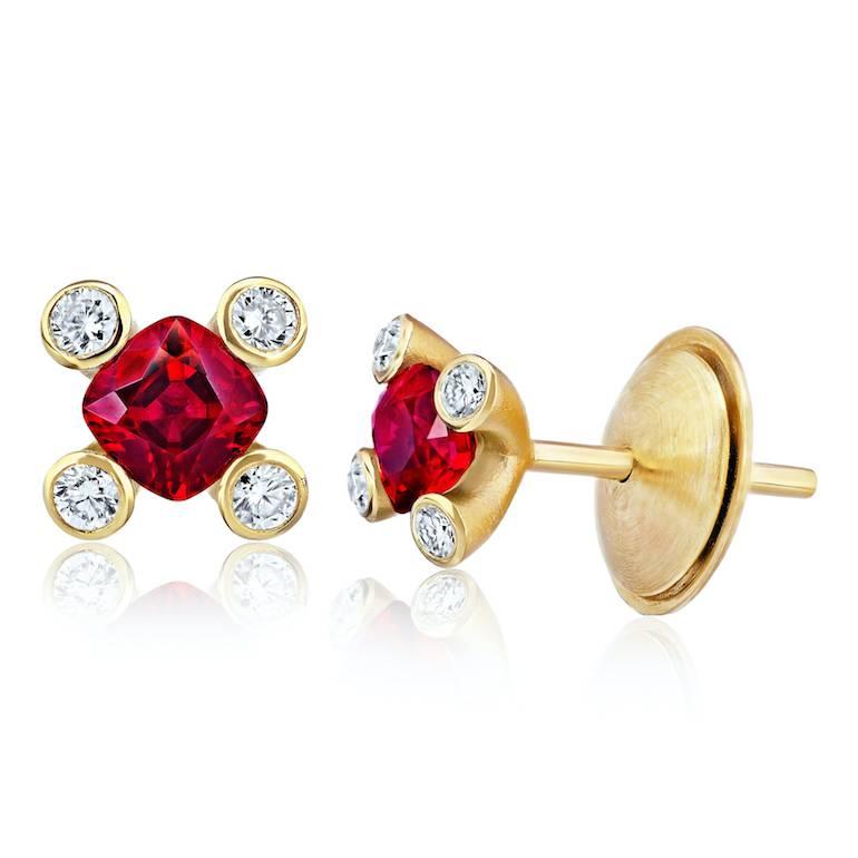 Two matched cushion cut red rubies weighing .90 carats set with eight round diamonds (F+/VVS) weighing .16 carats in 18k yellow gold earrings

