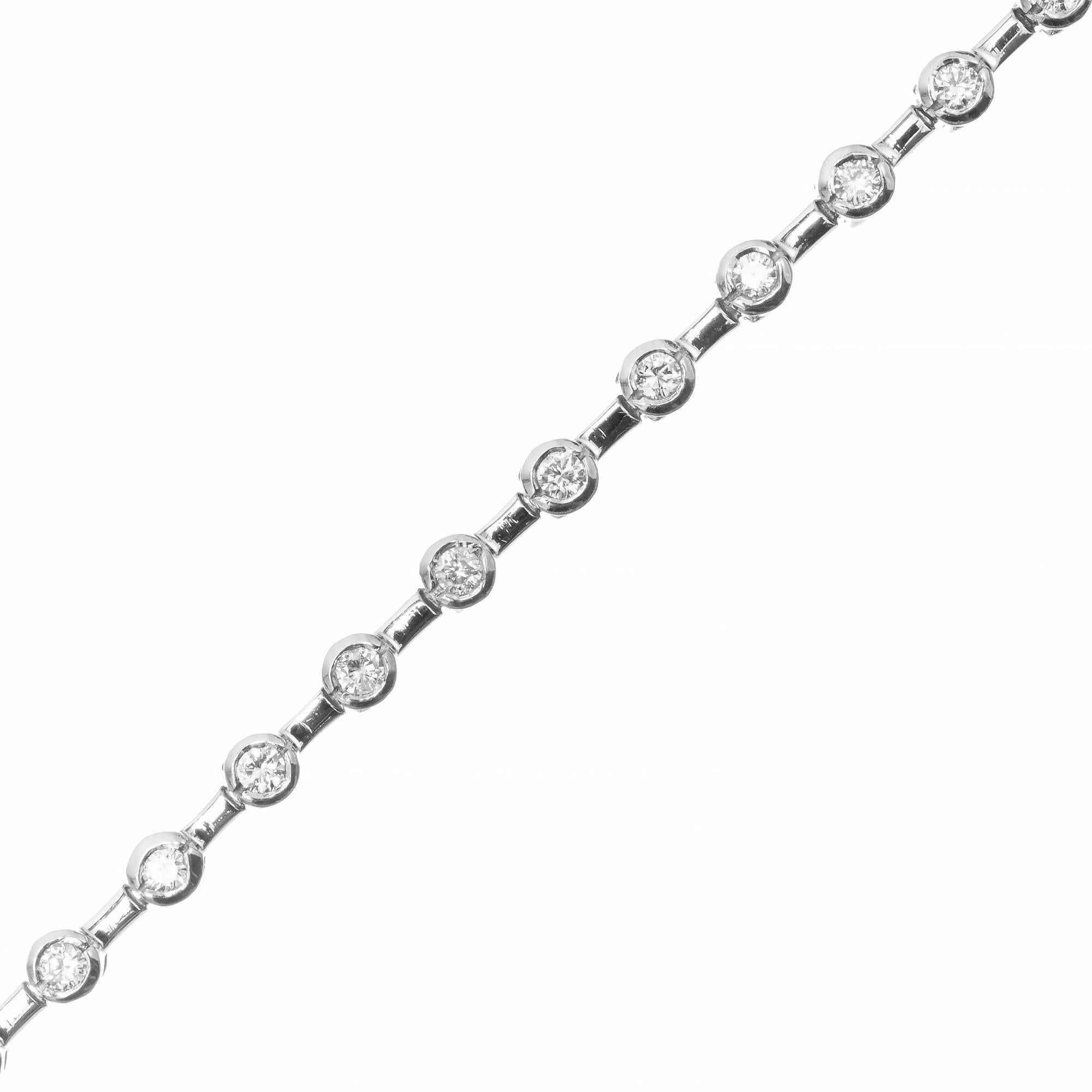 Diamond tennis bracelet. .90cts round cut diamonds, each set in 14k white gold bezel's separated by 14k white gold bars. 7 inches long. 

28, round cut diamonds approx. total weight: .90cts SI1 H
14k white gold
Length: 78 inches