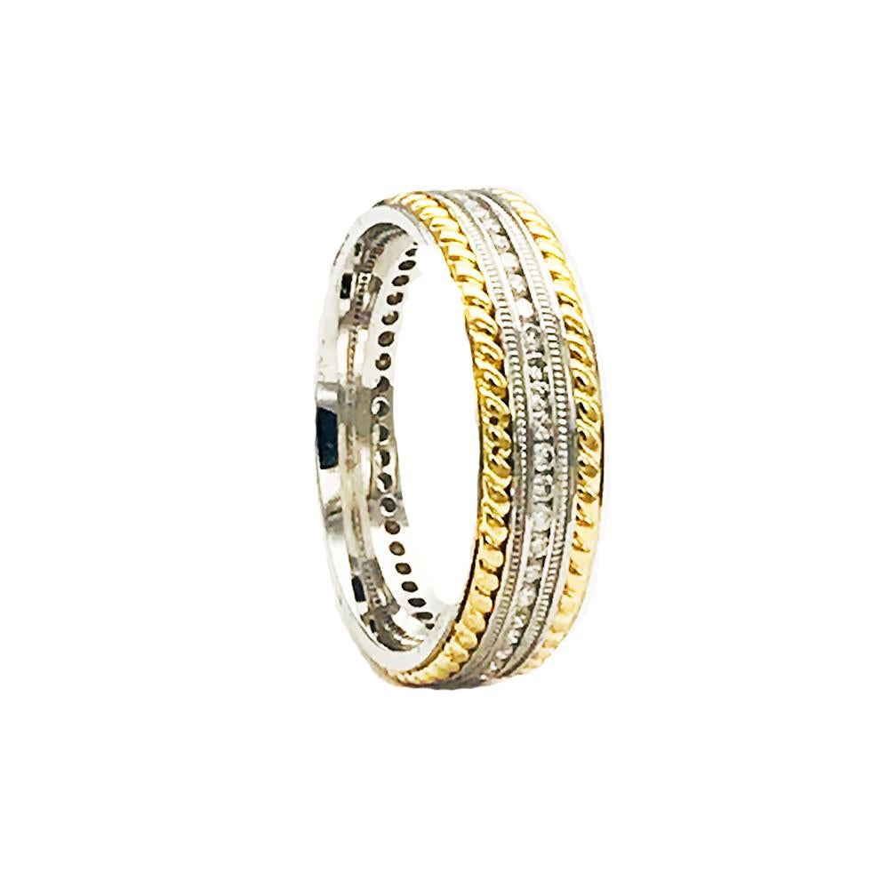 Brand new, Artcarved 14 karat yellow and white gold diamond eternity band measuring 6.75 mm wide. The diamonds are channel set in center of ring having a total weight of approximately .90 carat. The quality of the diamonds are SI1 clarity and H