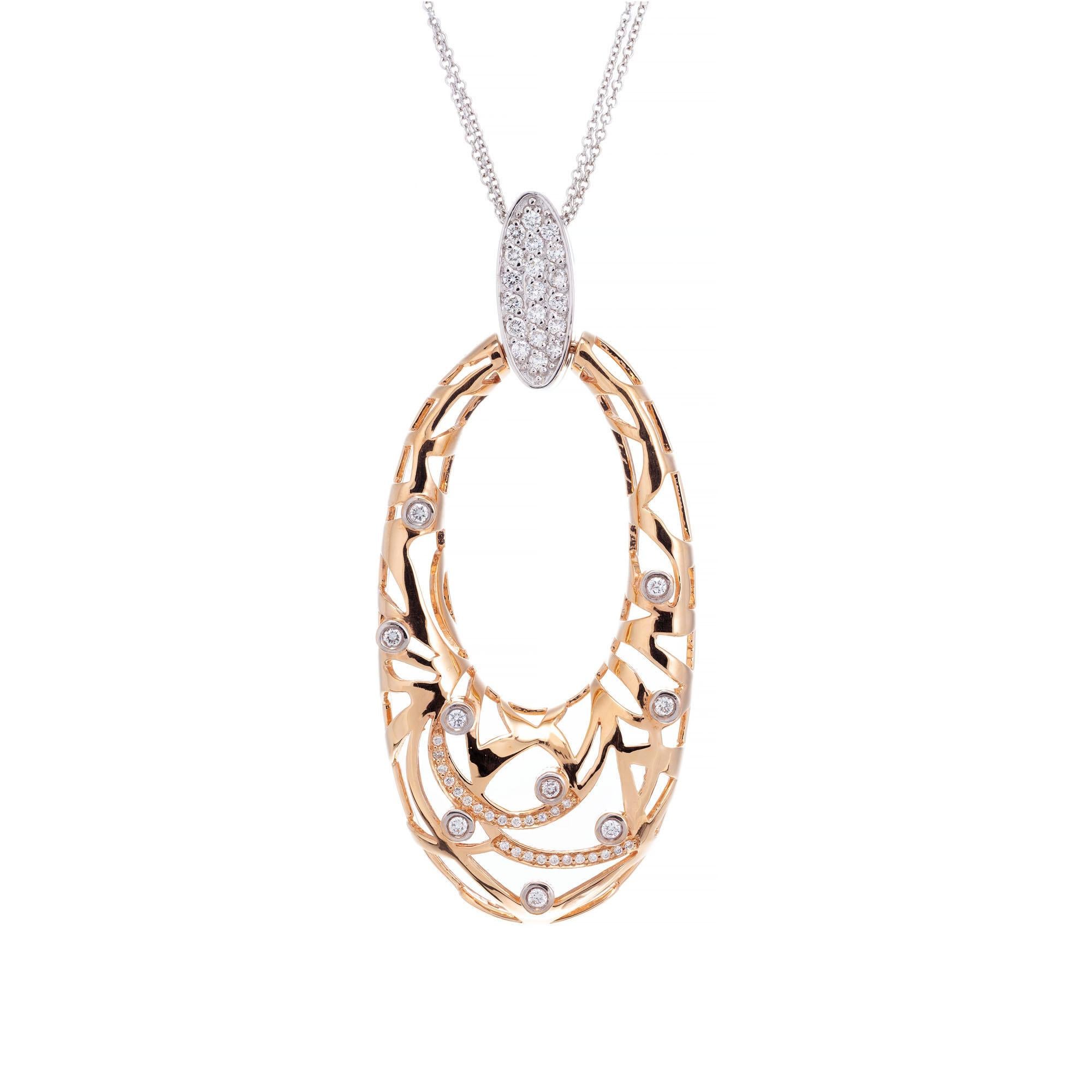 Rose gold open work elongated oval set with 53 full cut diamonds, white gold pave set bail and double white gold chain. Signed MS CO.

53 round diamonds¸ approx. total weight .90cts, G, VS1 – SI1
18k white and rose gold
Tested: 18k
Stamped: