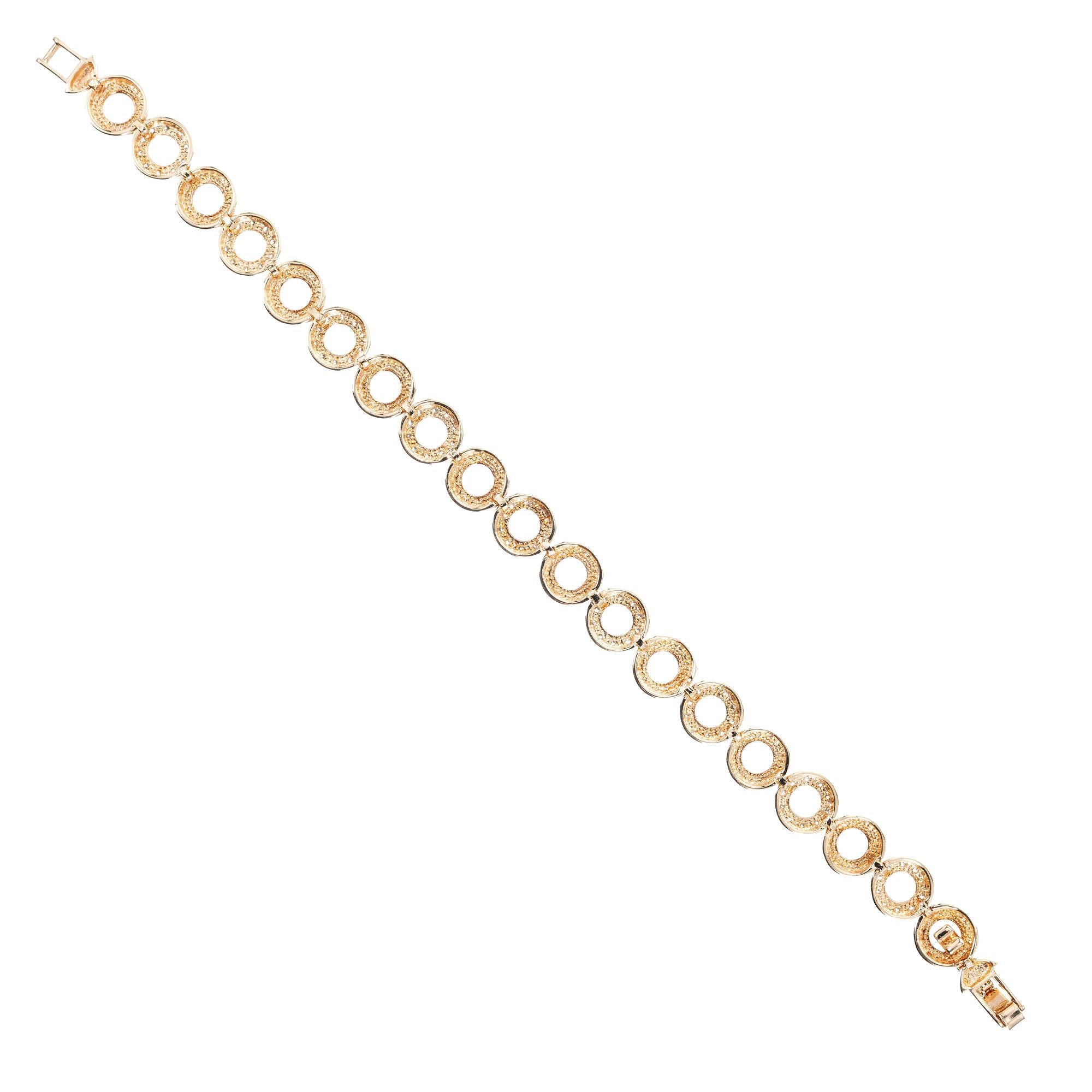 Open circle 14k yellow gold bracelet with every other link is bead set with .90cts of diamonds. 7 inches in length. 

90 round diamond, H SI approx. total weight .90cts
14k yellow gold
Tested: 14k
9.4 grams
Length: 7 inches – Width: 8.23mm – Depth: