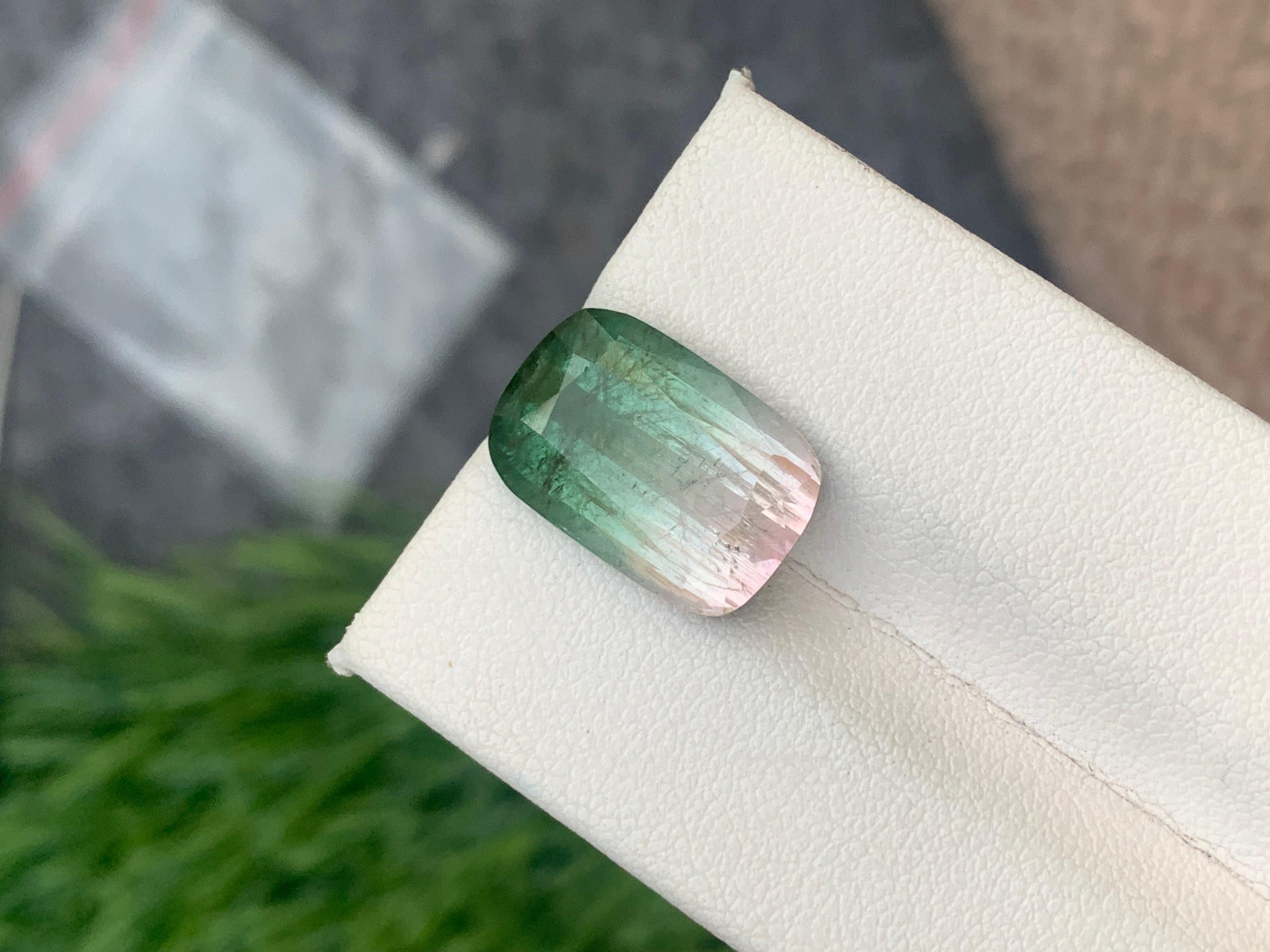 Bicolor Tourmaline 
Weight: 9.0 Carats
Dimension: 15.4x10.4x6.8 Mm
Origin: Afghanistan
Color: Pink Green
Shape: Cushion

.
Bicolor tourmaline is connected to the heart chakra, which makes it good for cleansing and removing any blockages. The stone