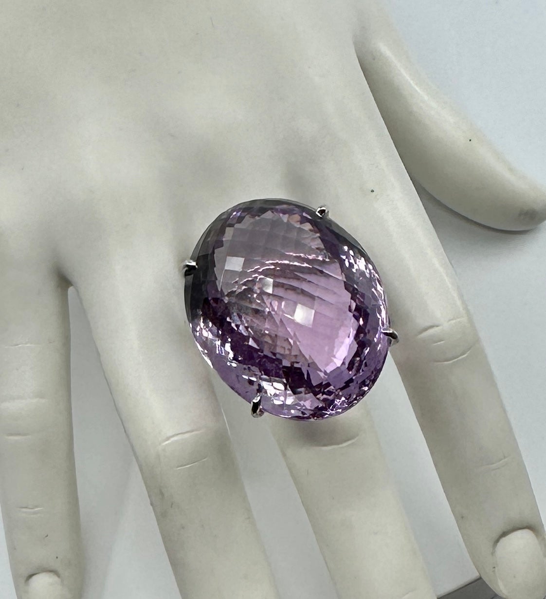This is an extraordinary monumental 90 Carat Amethyst Ring with a stunning oval checkerboard faceted natural Rose de France Amethyst in a classic setting in Sterling Silver.  The monumental amethyst is 37mm (1 1/2 inches) by 30mm by 20mm.  The