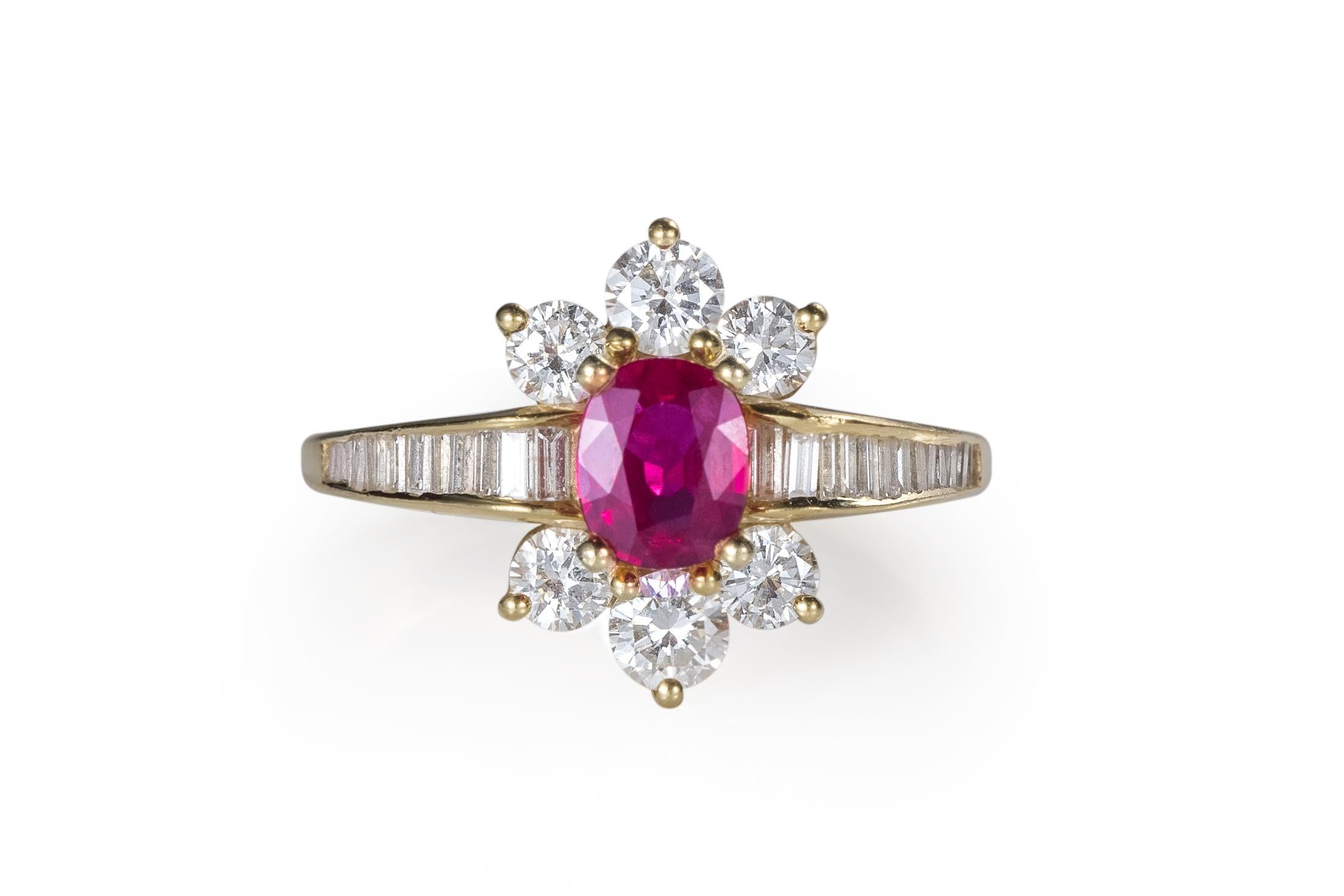 Item Details:
Metal Type: 18 Karat Yellow Gold
Weight: 5 grams
Size: 7 (Resizable)

Ruby Details:
Carat: .90 Carat
Cut: Oval Brilliant
Color: Blood Red 
Gem Quality 

Diamond Details:
Cut: Round Brilliant and Baguette Cut
Color: E F
Clarity: