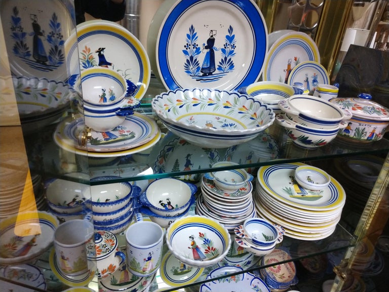 Large collection of Quimper pottery dish set. Runs the gamut from porridge, salad, cake lunch and dinner plates in varying degrees of number and conditions. Cake plate pedestal, serving platters, veg dishes.
Antique to 20th century, some with cracks